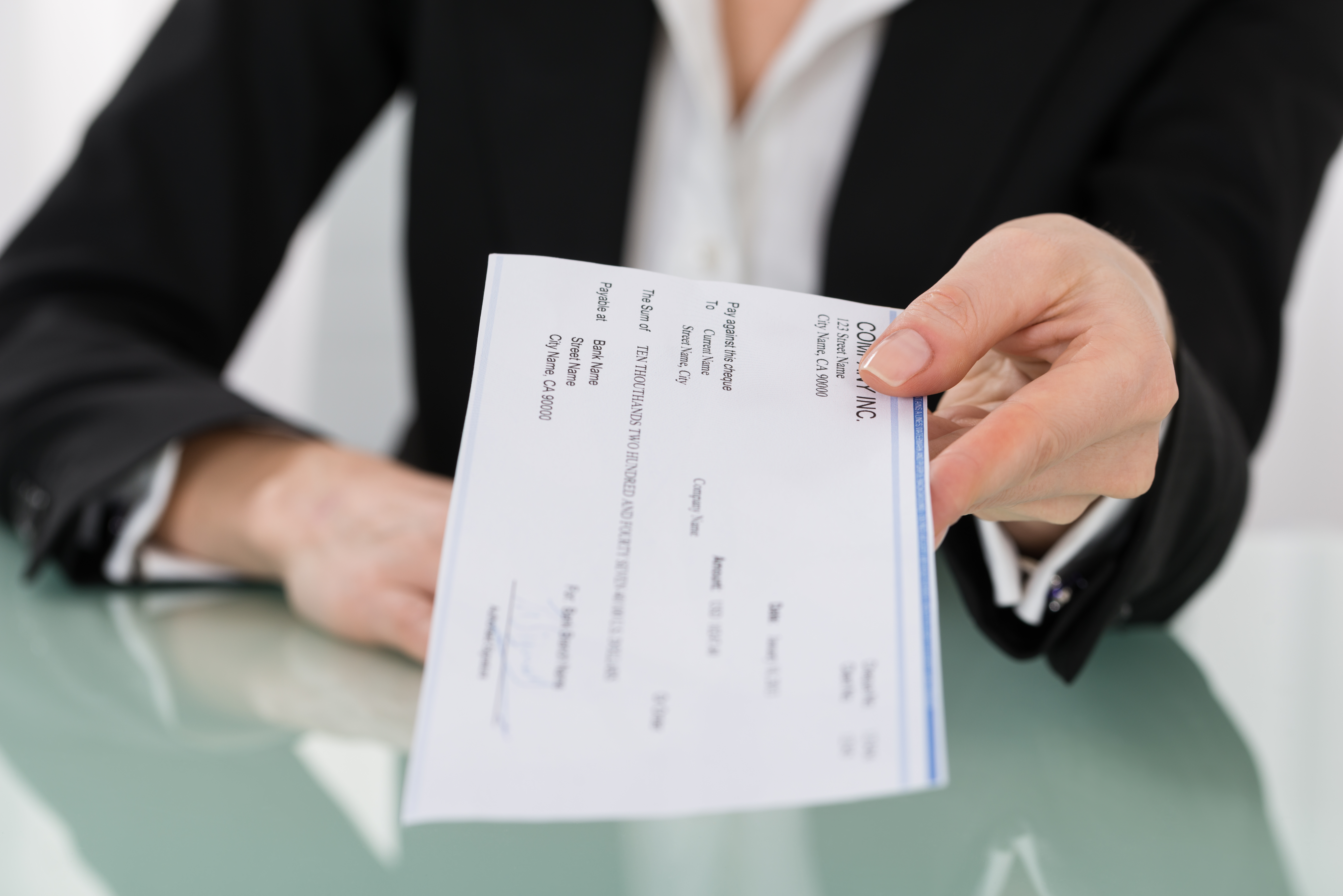 Businesswoman Hand Giving Cheque