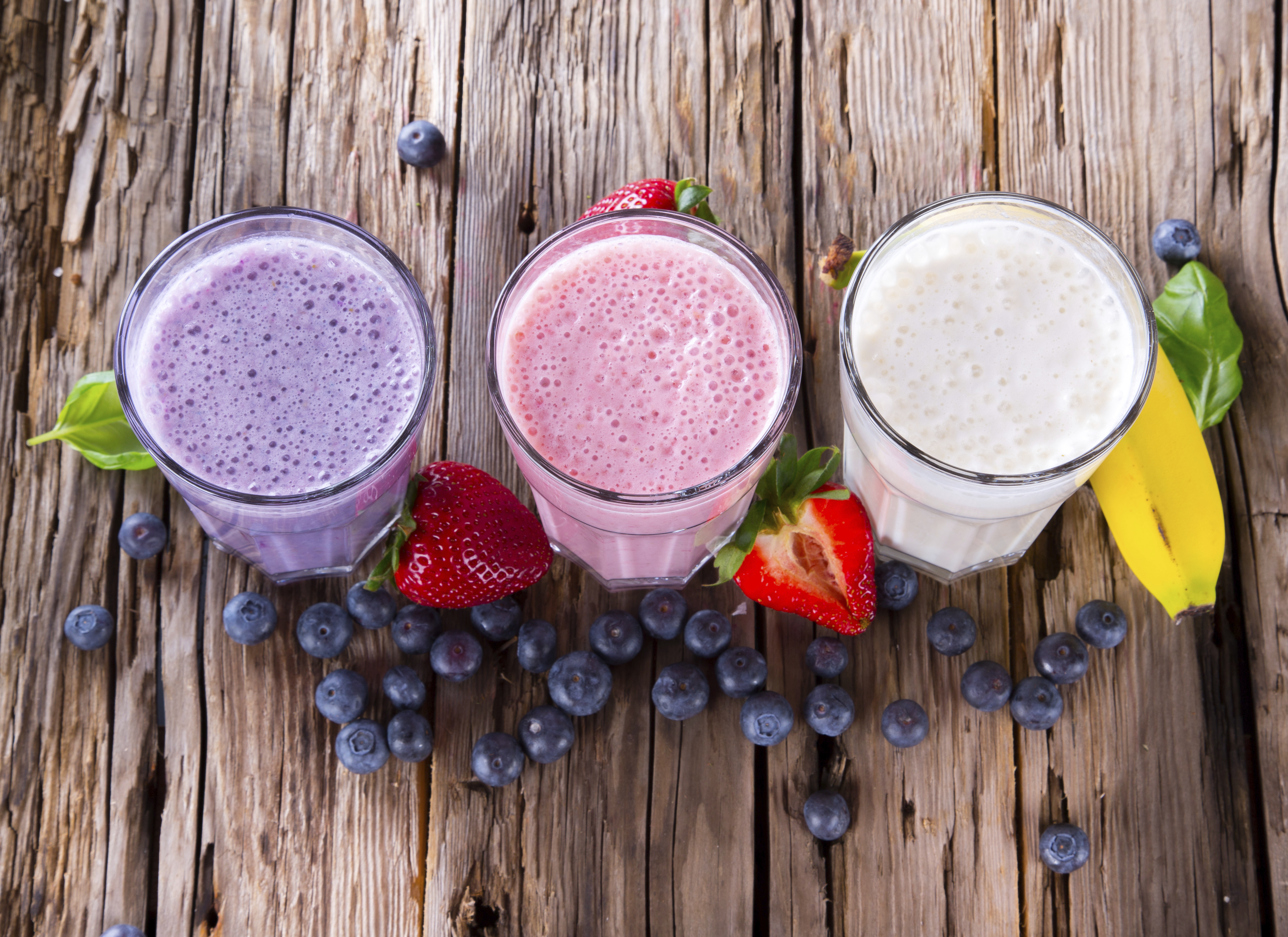 Fresh fruits milk shake on wood