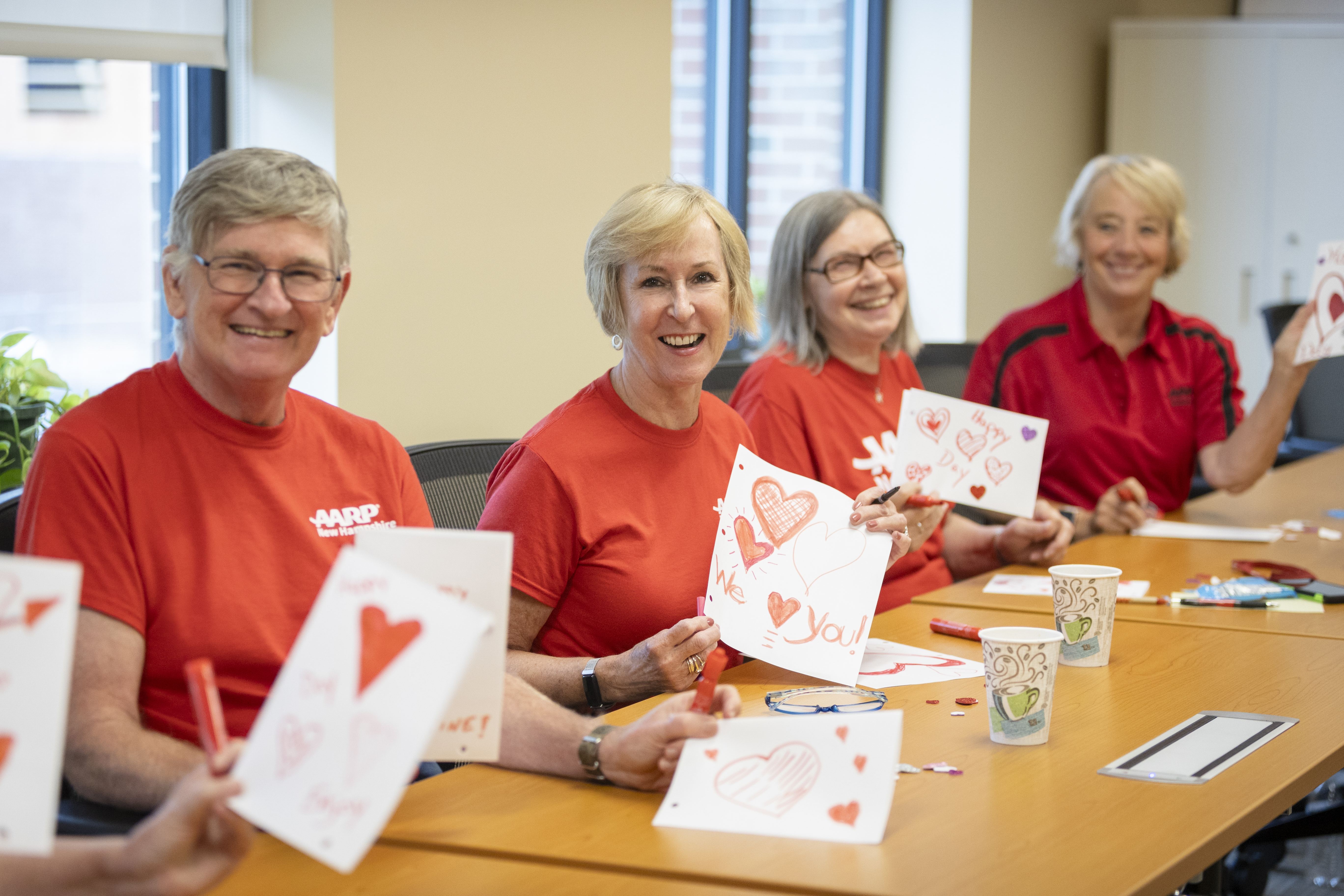 AARP volunteers write valentines.
