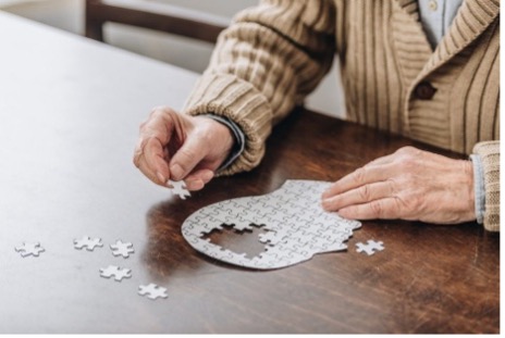 A woman's hands complete a puzzle