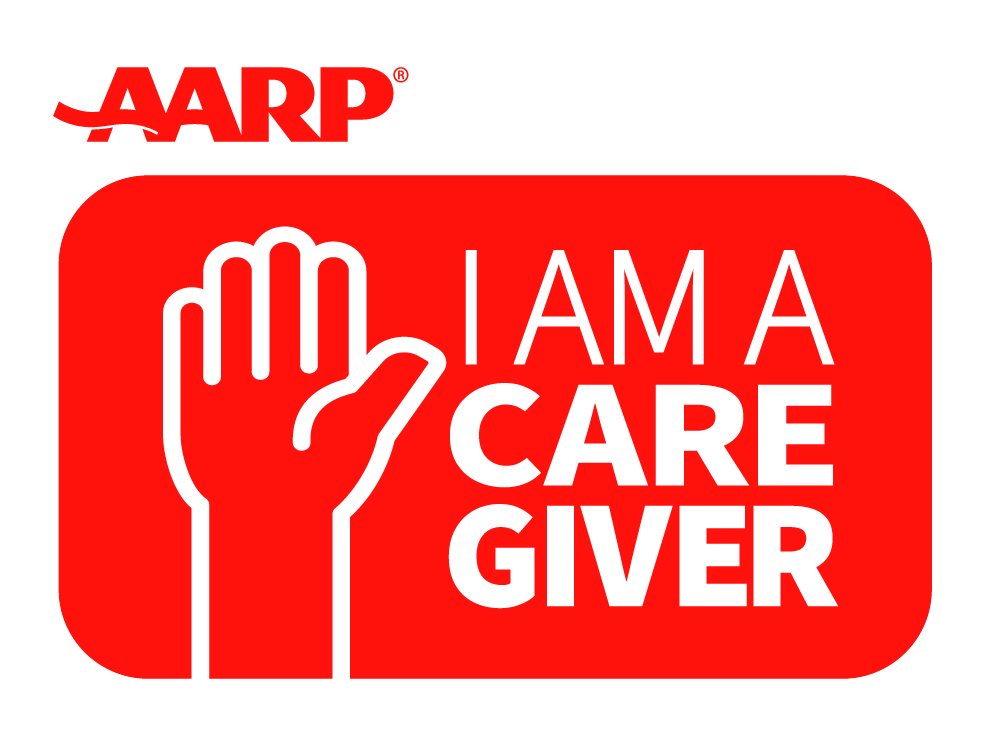 AARP caregiving logo featuring a red background and the outline of a hand on the left side with the words "I Am A Caregiver" on the right.
