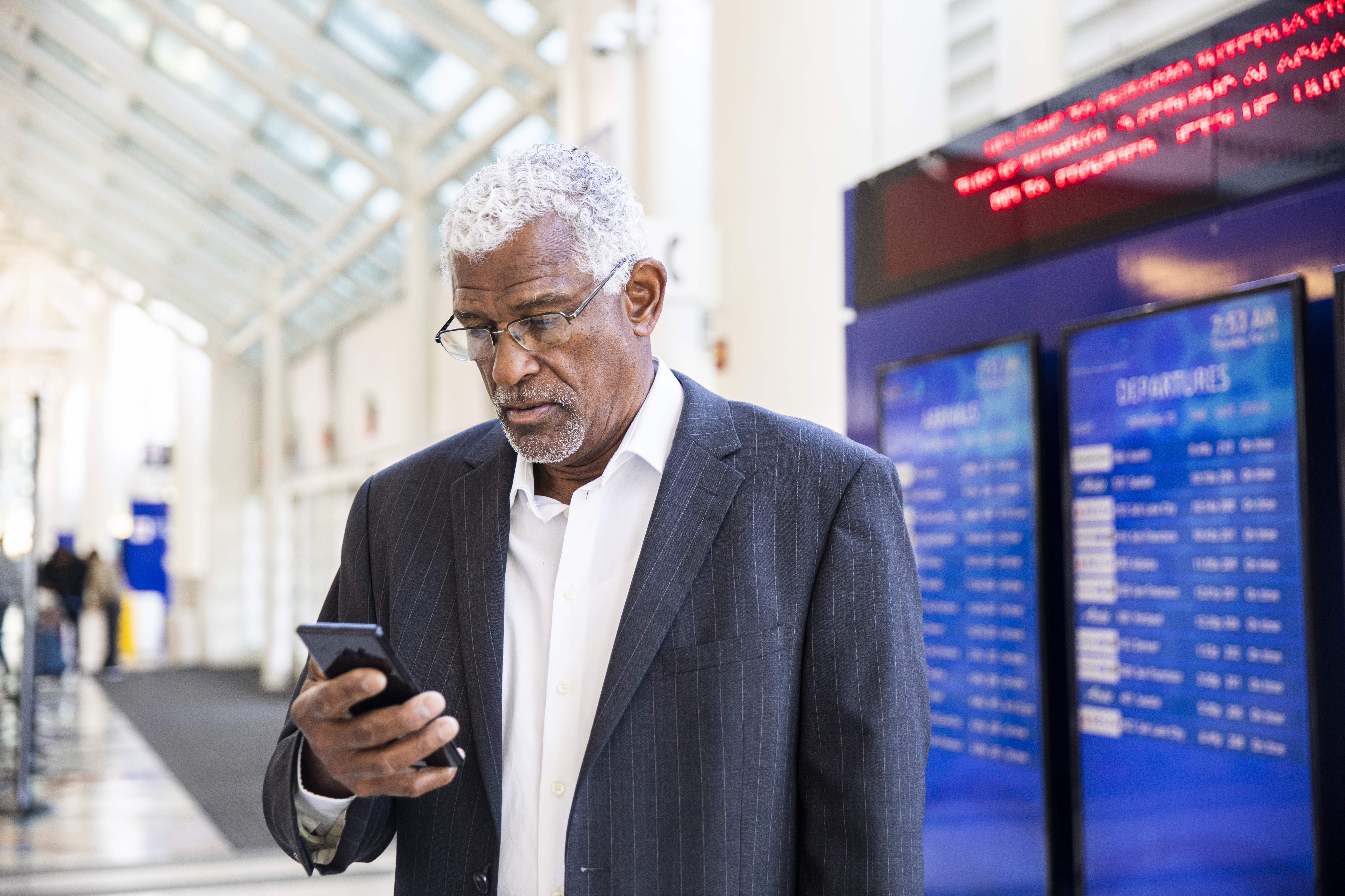 Senior Black Businessman on Phone at the Airport