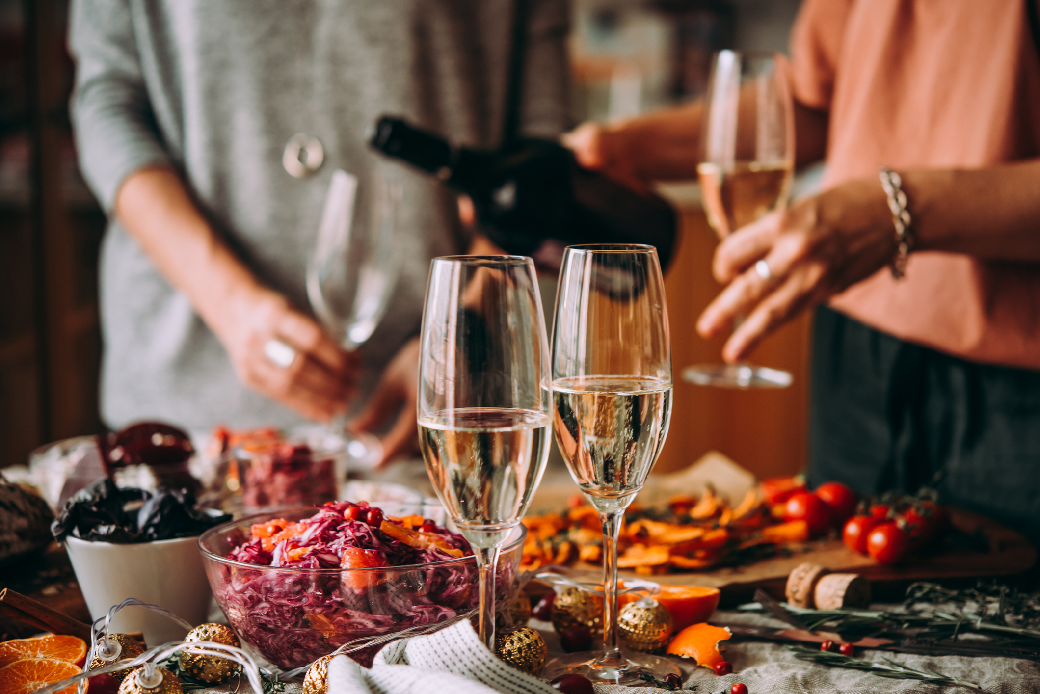 Family pouring drinks at a table filled with food