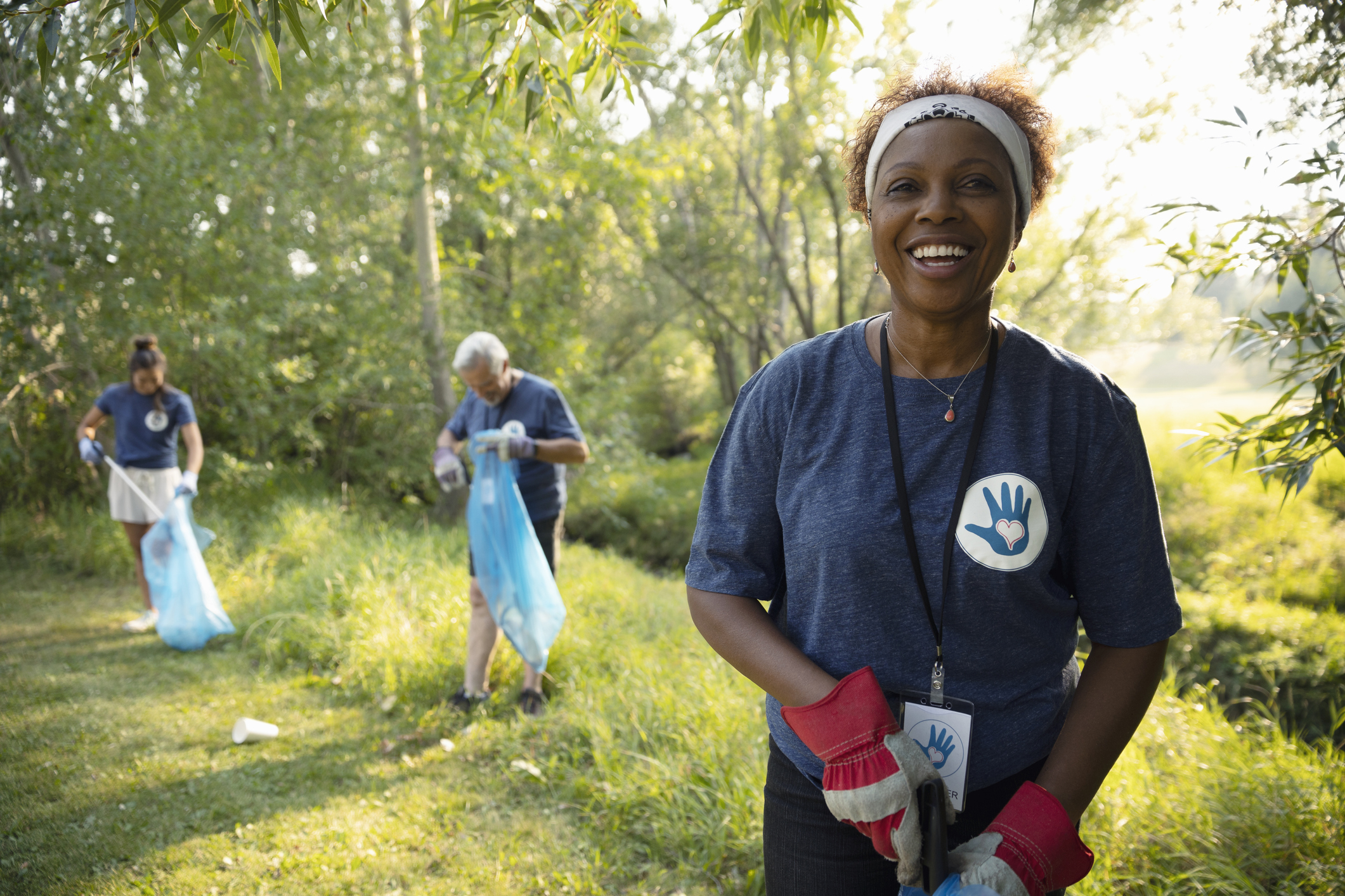 Portrait confident senior woman volunteering, cleaning up garbage in park