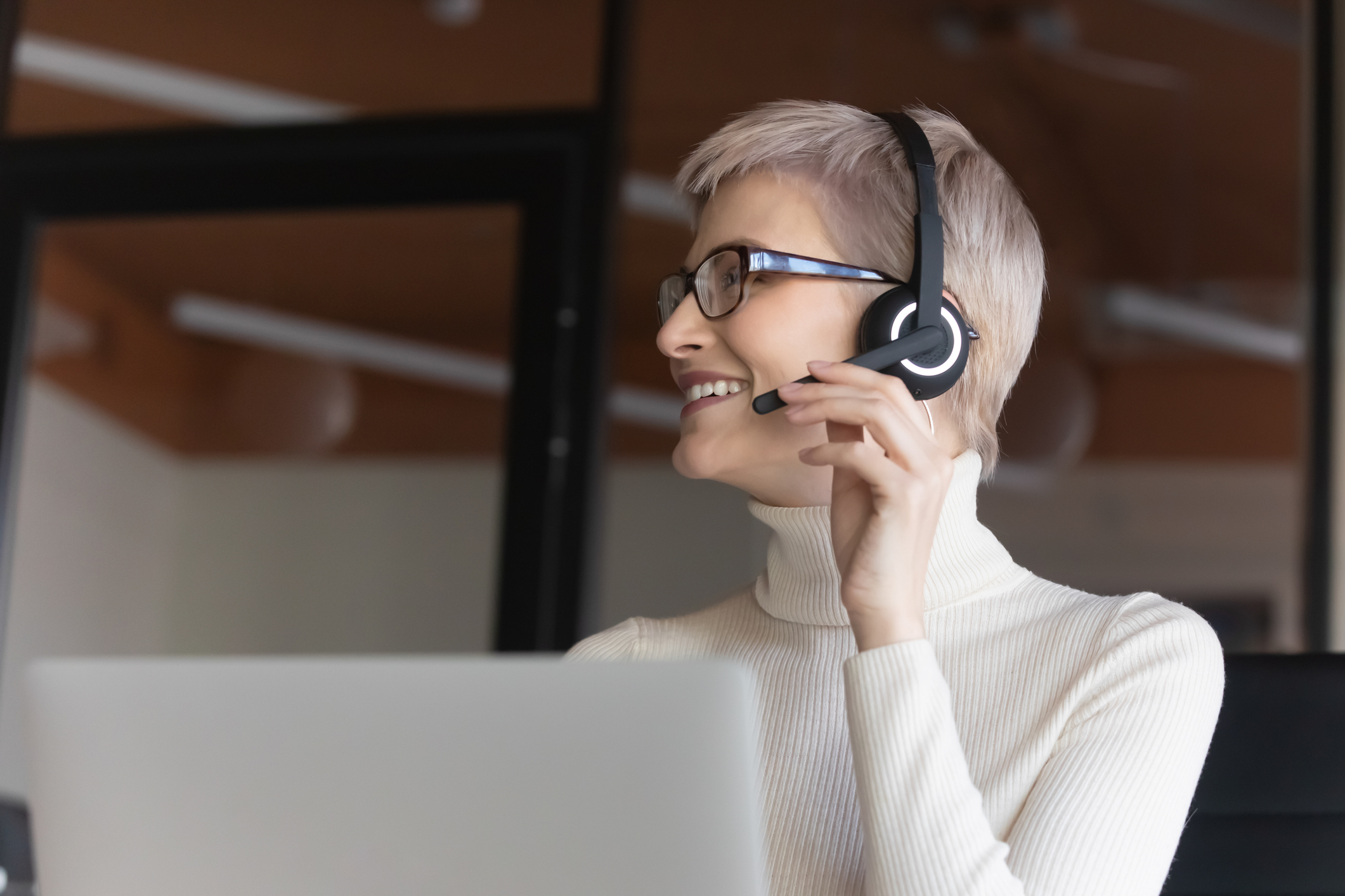 Happy young businesswoman consulting with colleague in office.