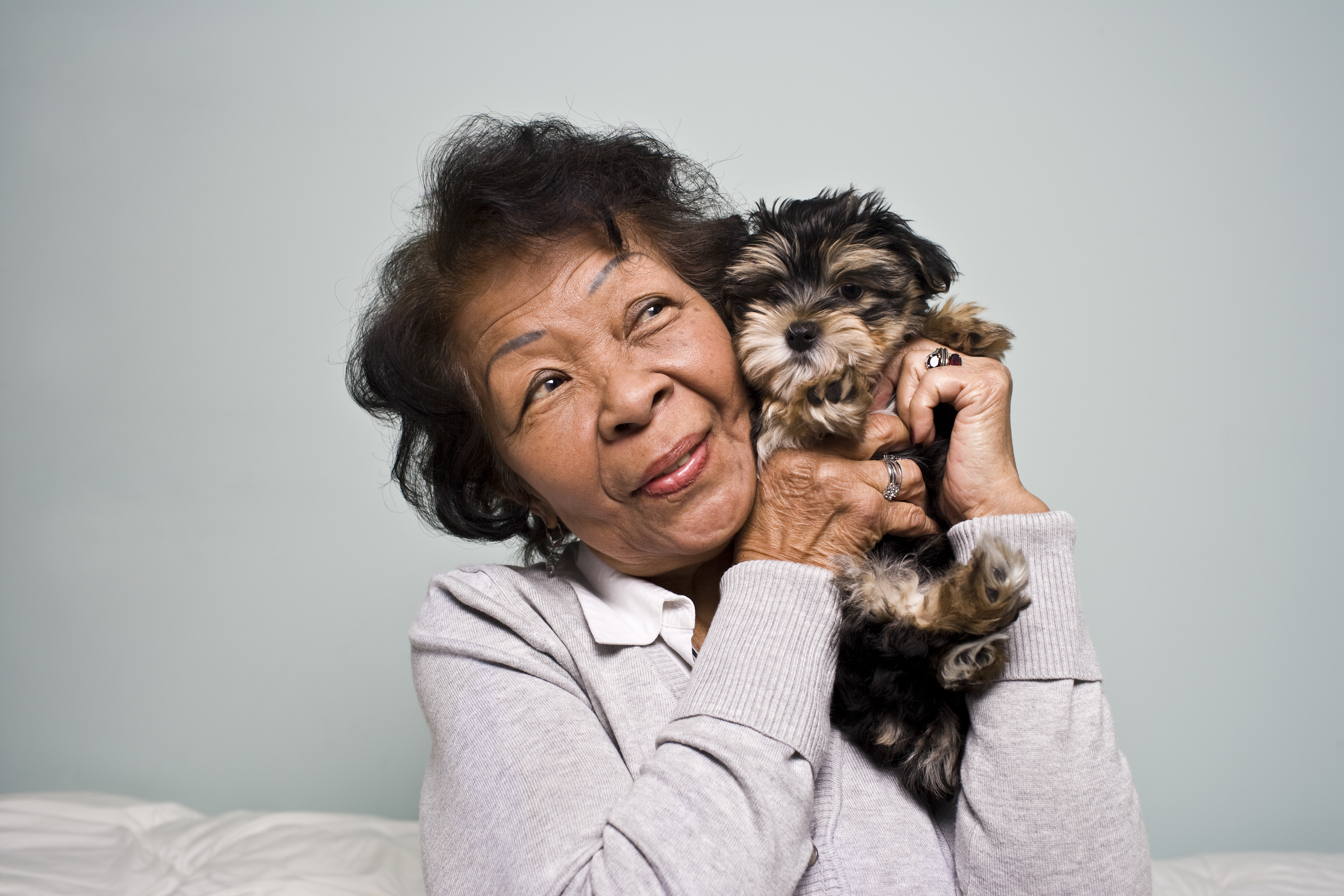 Senior Woman holding a Puppy