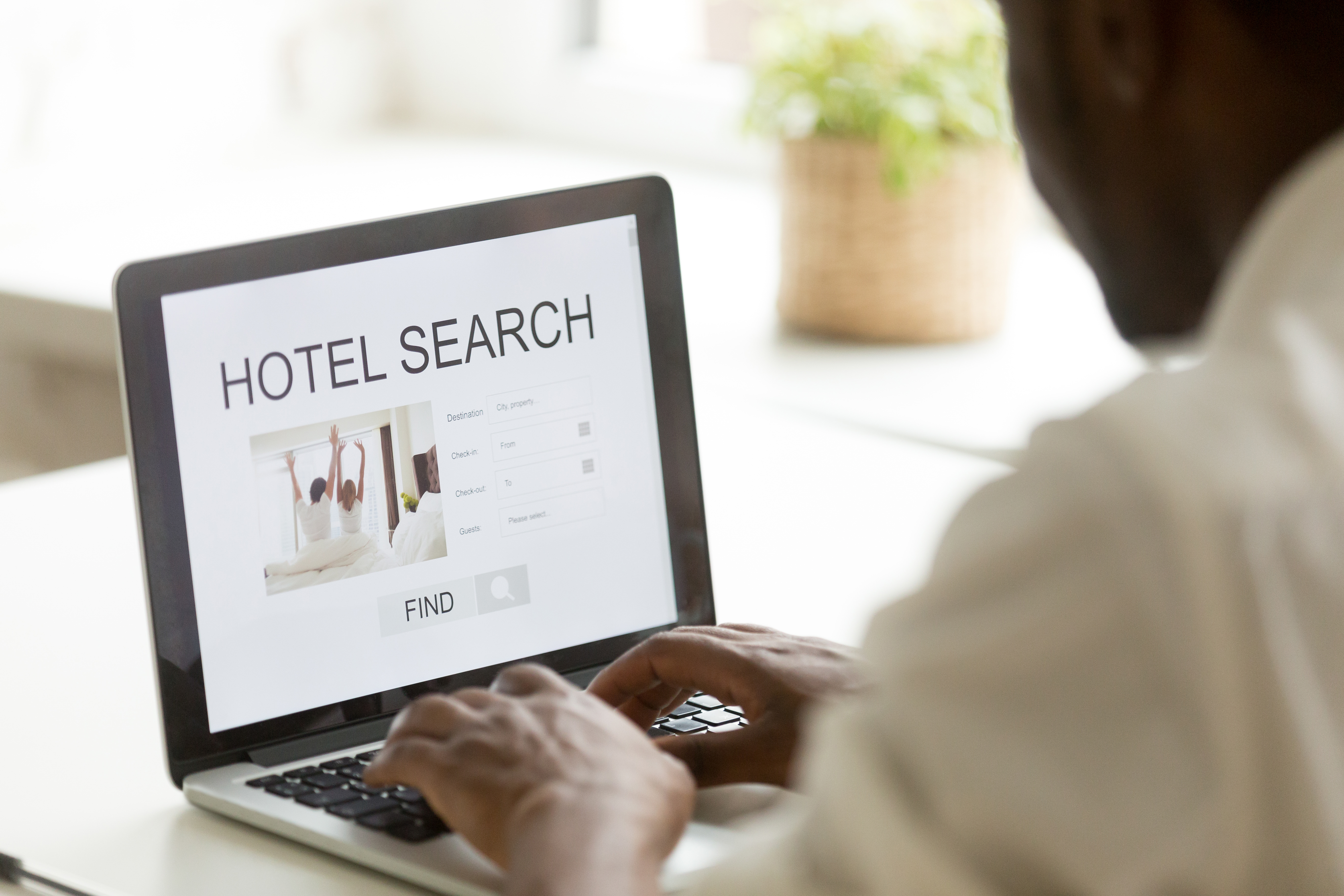 African-american man browsing hotel online using search app on laptop