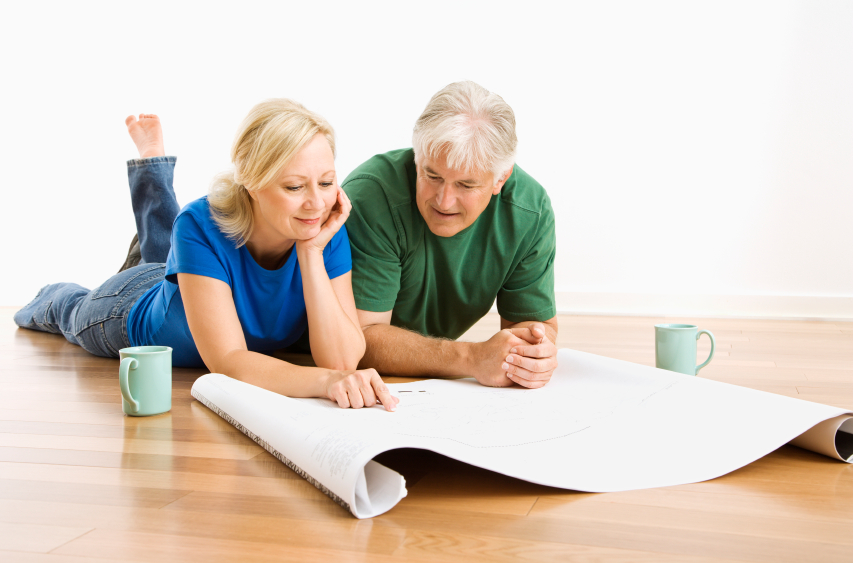 Man and woman discussing blueprints.