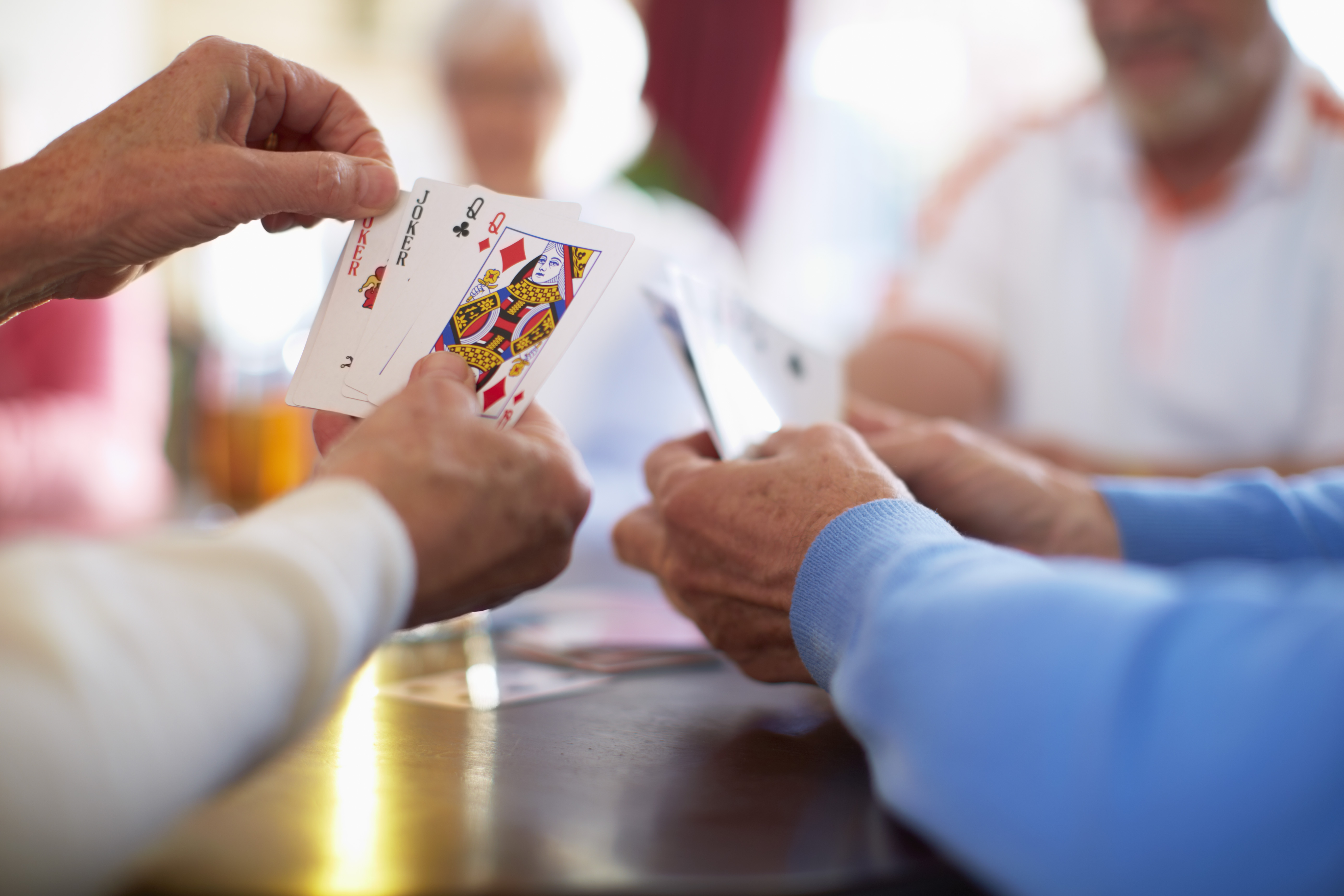 Senior friends playing cards