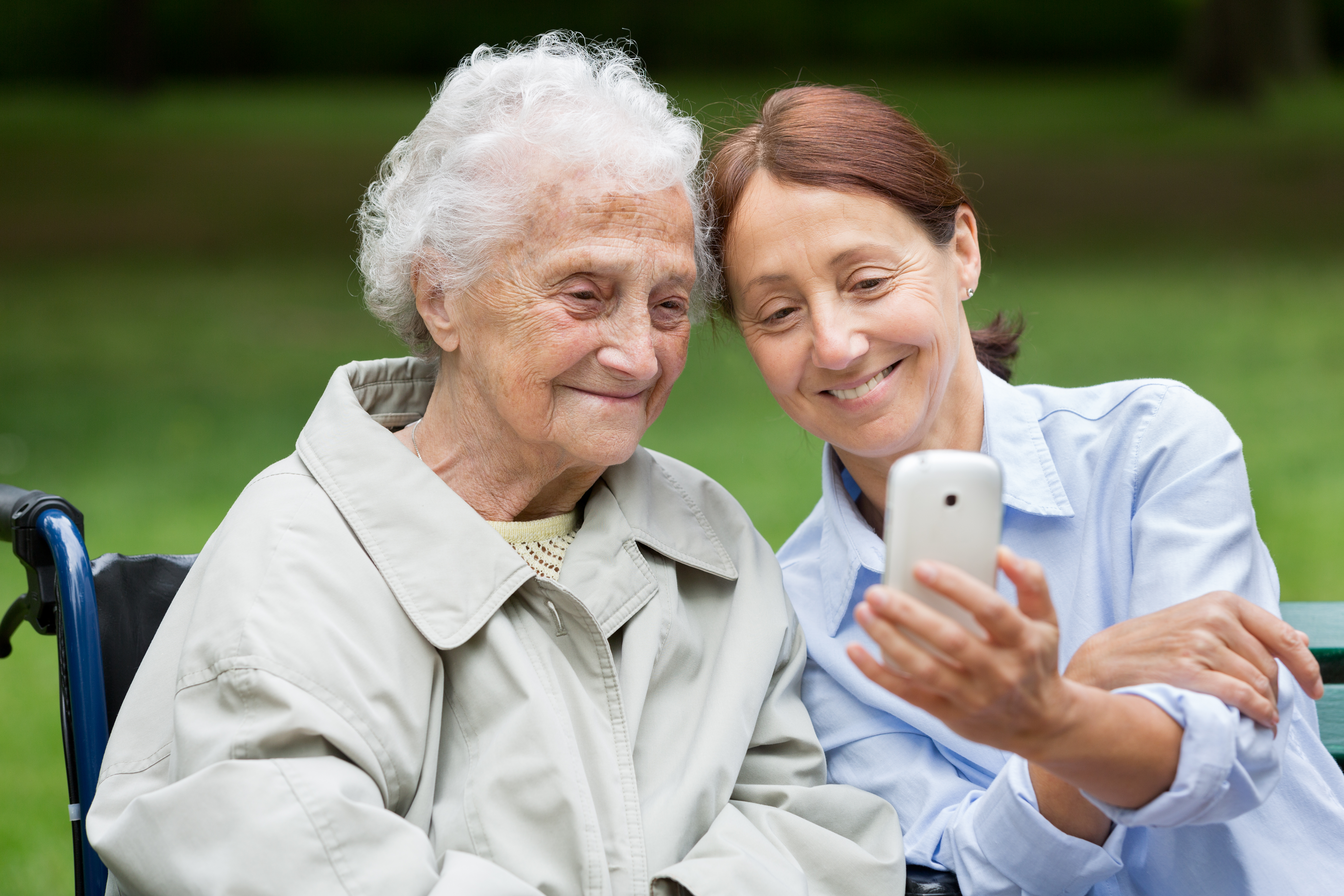 Senior woman with caregiver in the park