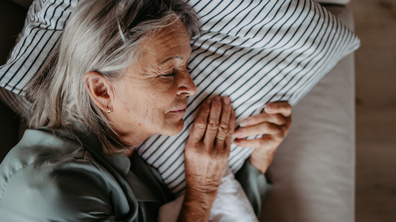 Top view of sleeping senior woman.