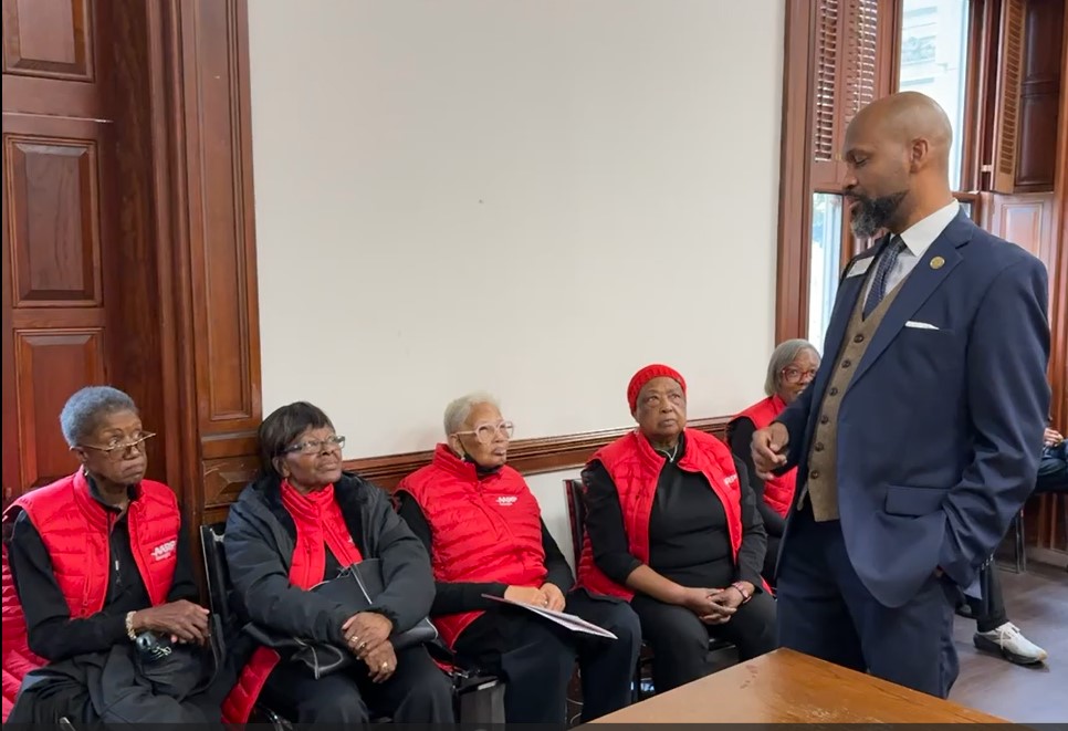 Rep El Mahdi Holly D 116 speaks with volunteers.jpg