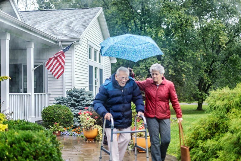 Getty Images: older couple walking from house on a rainy day