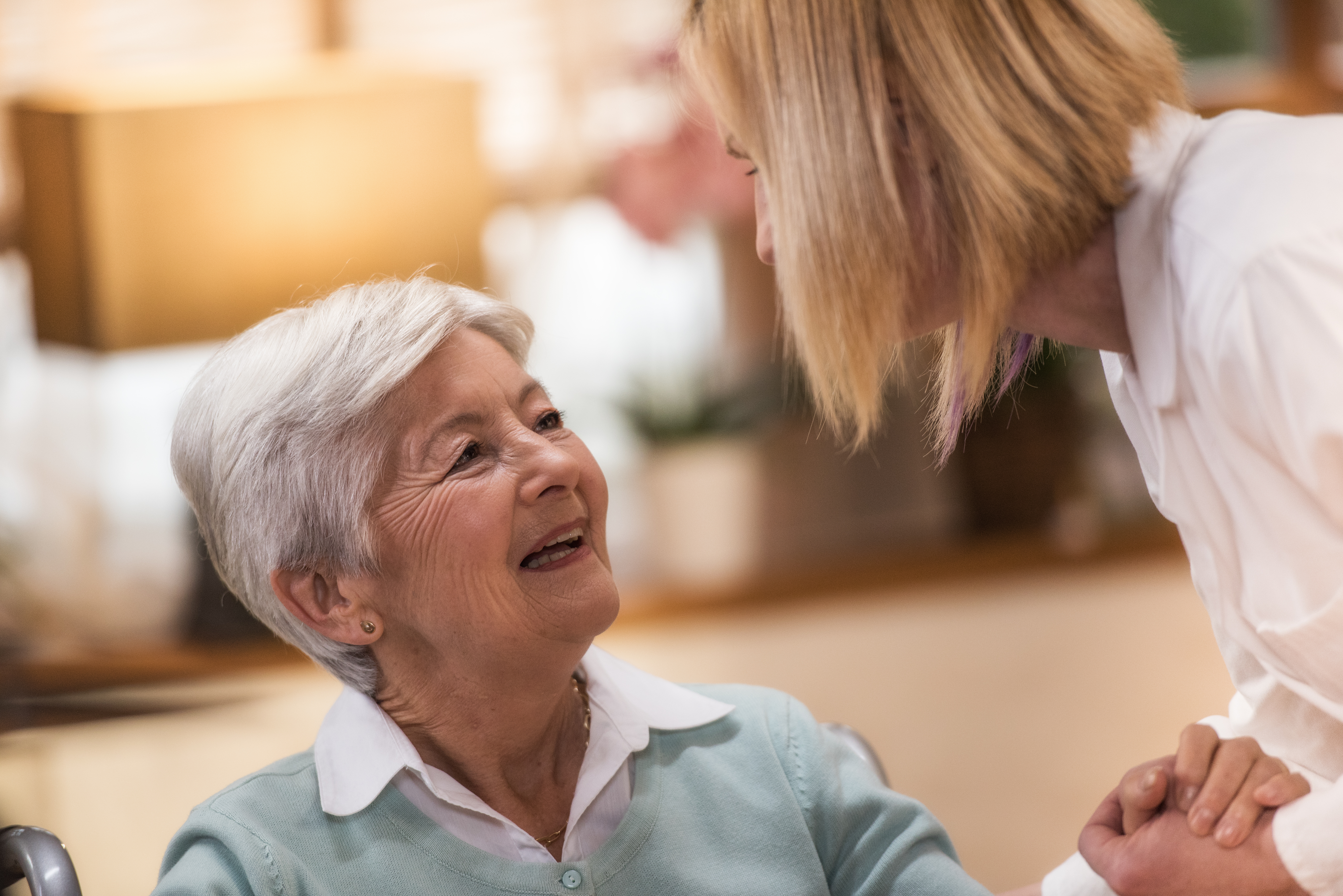 Nurse during home visit with senior woman