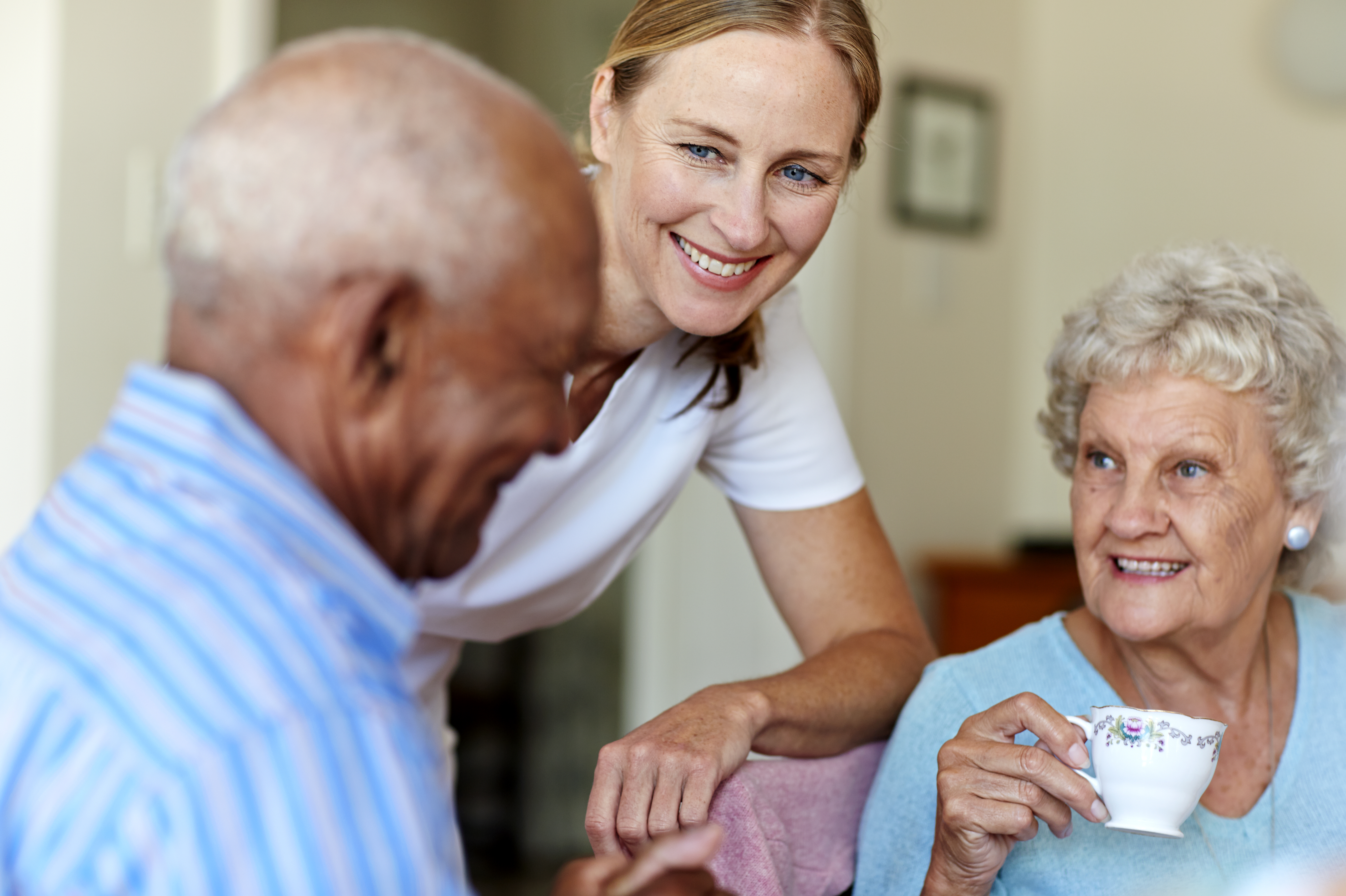 Caretaker with senior people in nursing home