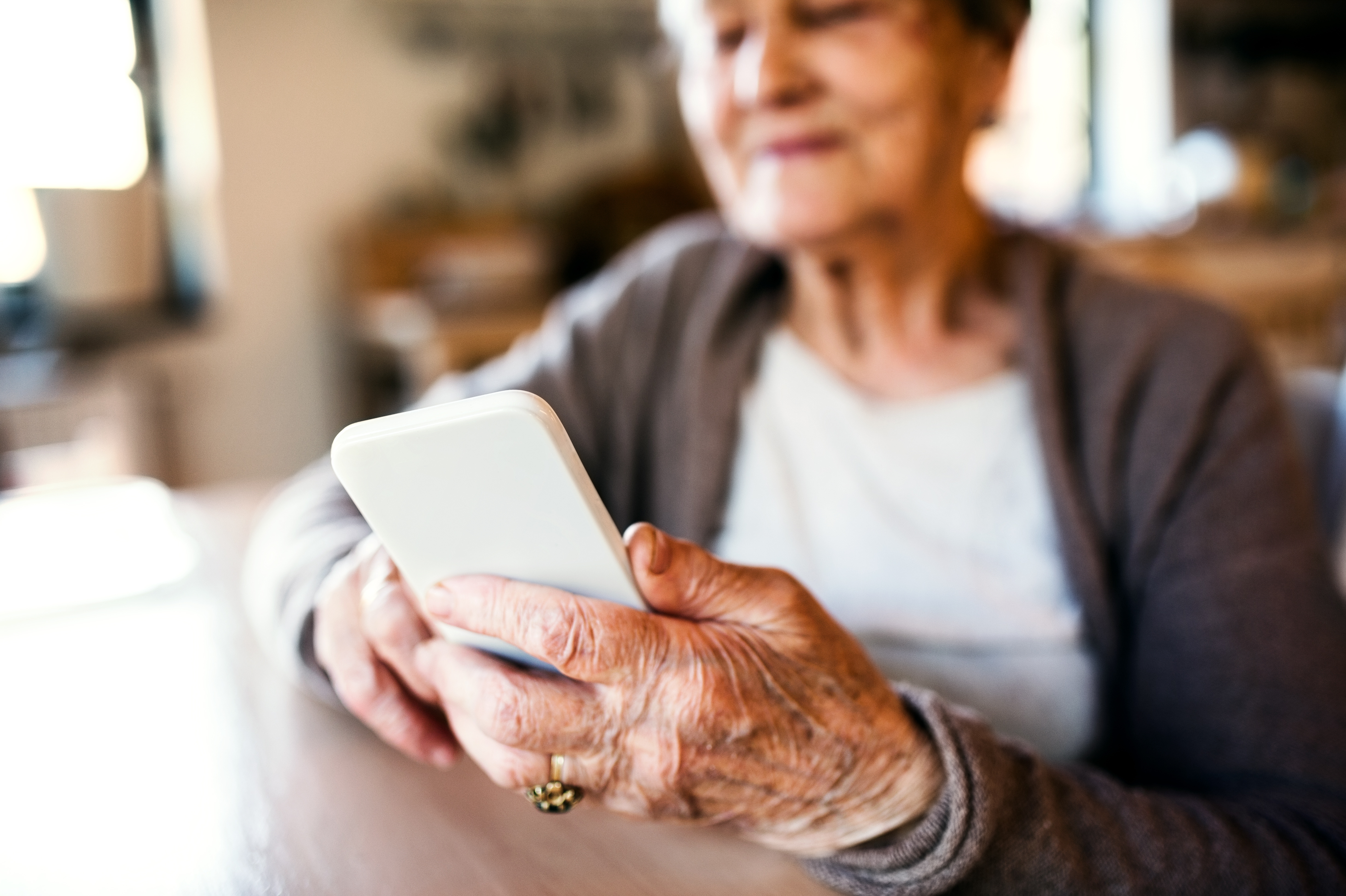 Grandmother at home using smart phone.