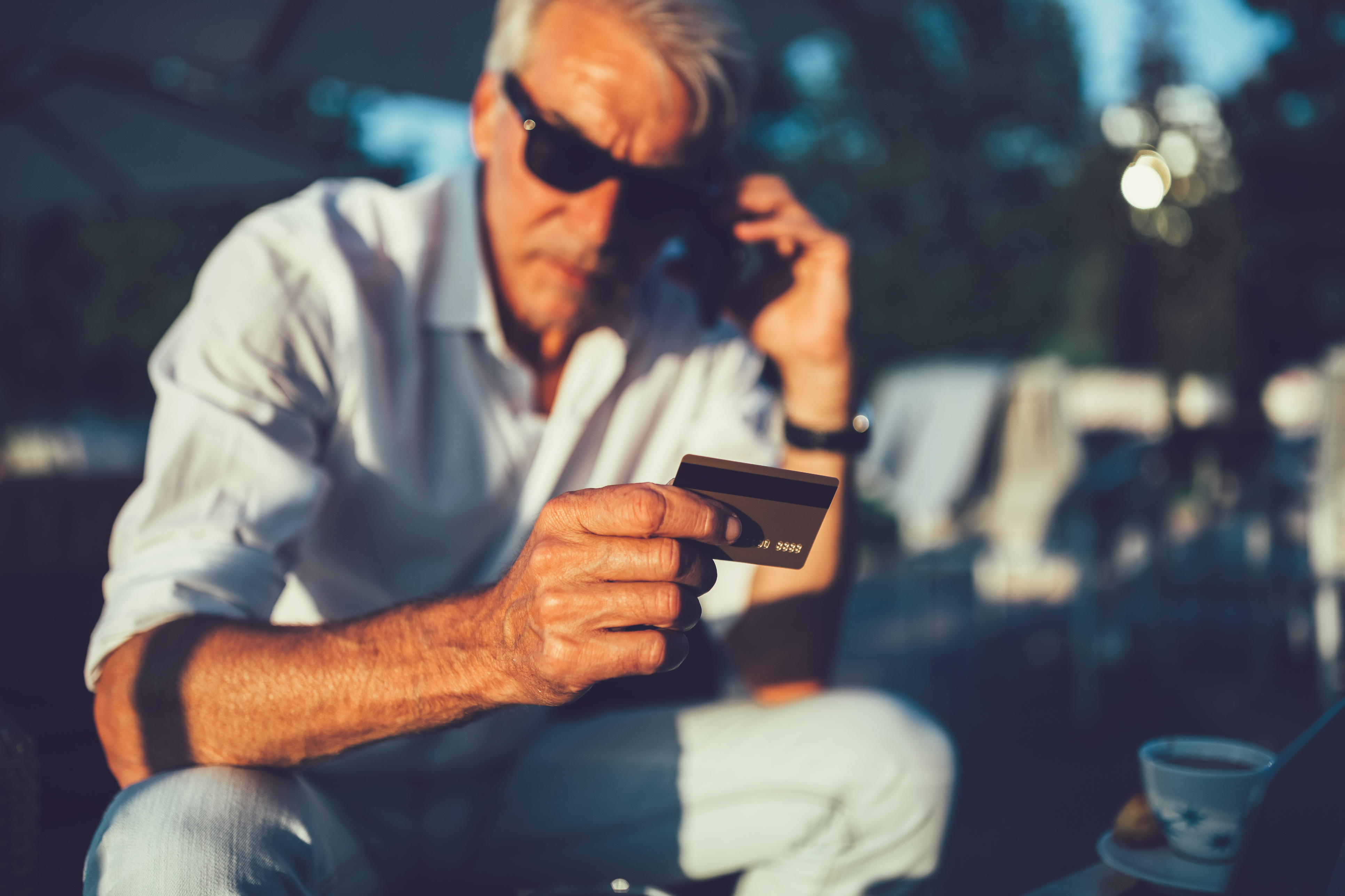 Senior man with credit card calling the bank
