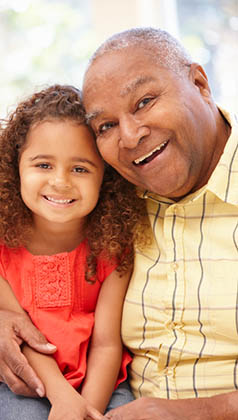 Senior African American man and granddaughter