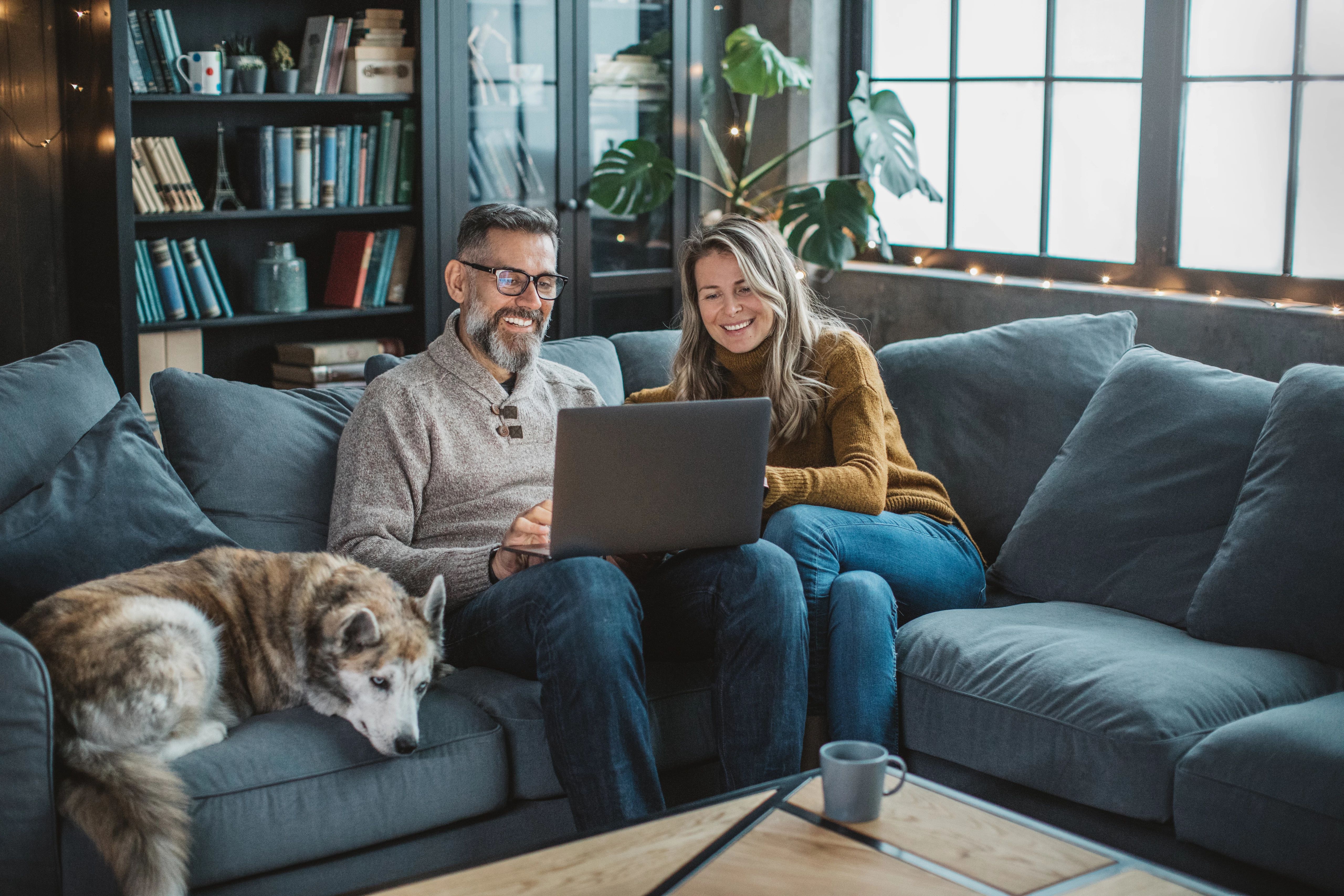 Mature woman at home taking classes online using her laptop