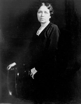 Hattie Caraway sits in a chair in this black and white photo from the Library of Congress