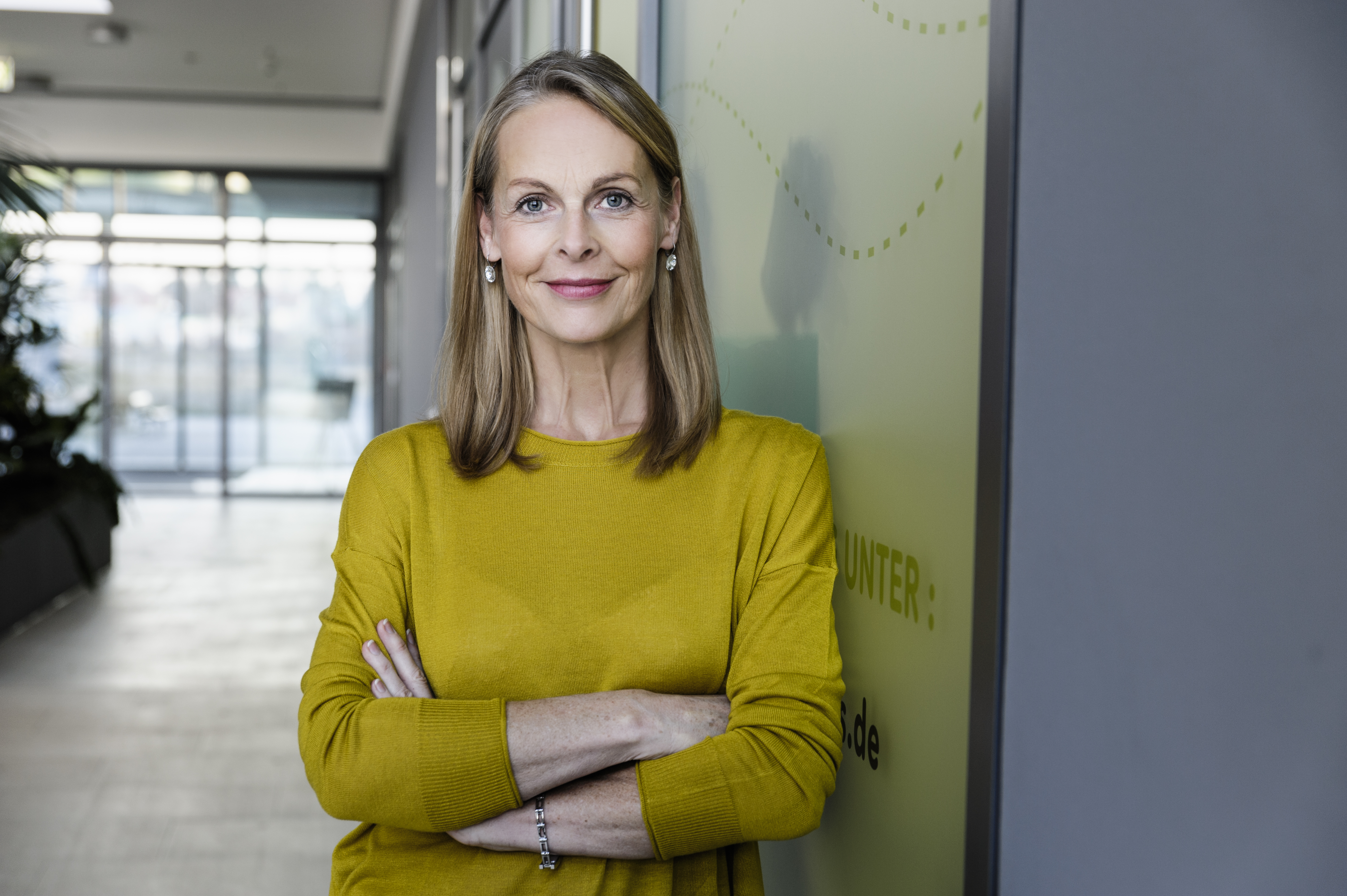 Portrait of confident mature businesswoman in office corridor
