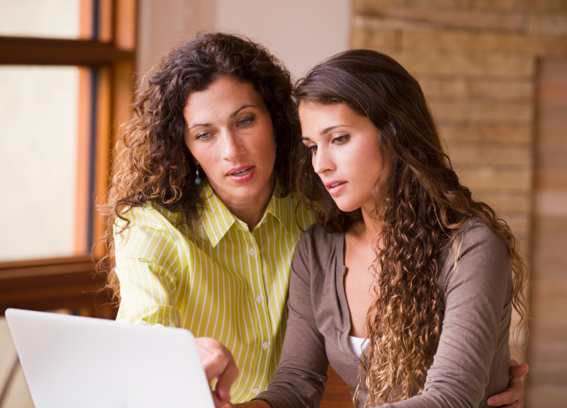 Student and teacher reviewing student loan applications