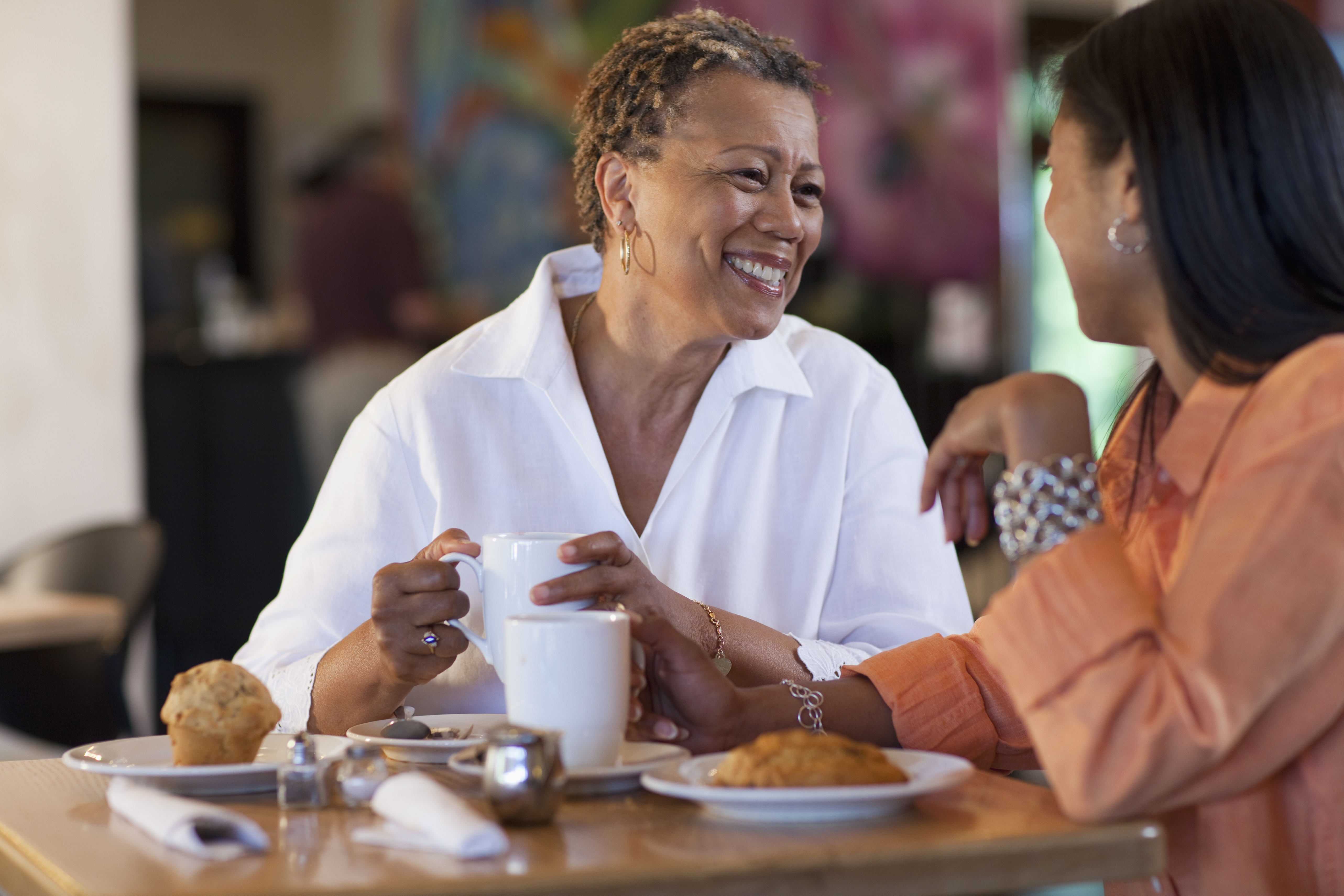 Mother and daughter having pastry in cafe