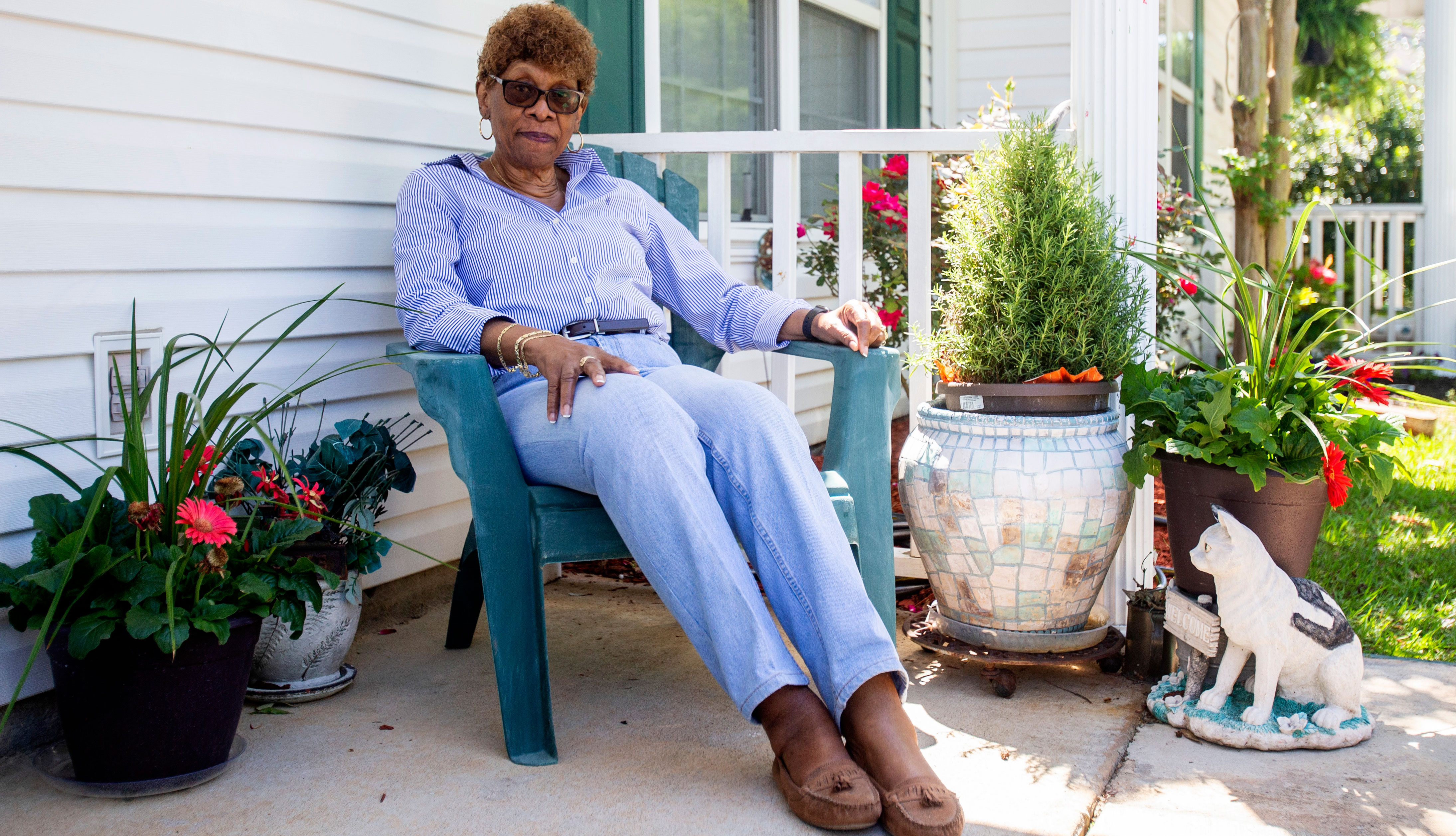 A woman sitting on her porch