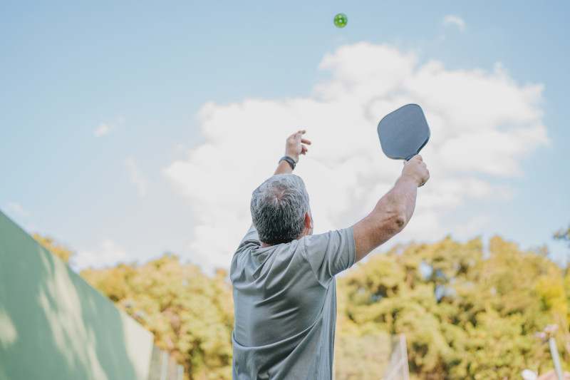 A man serves a ball. 