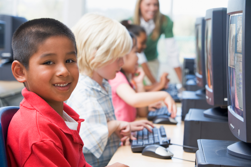 Kindergarten children learning how to use computers.