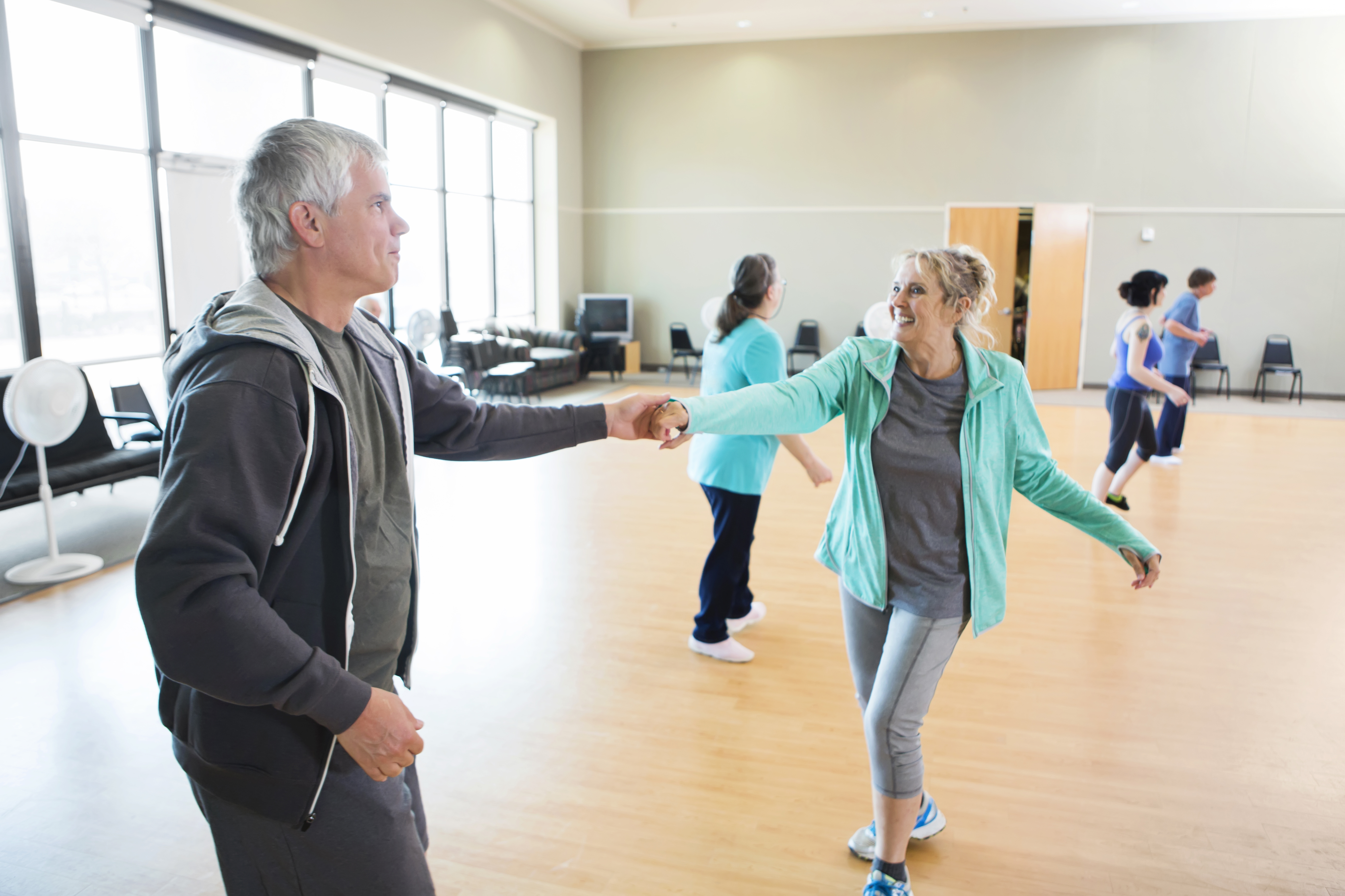 Senior couple take swing dancing lessons