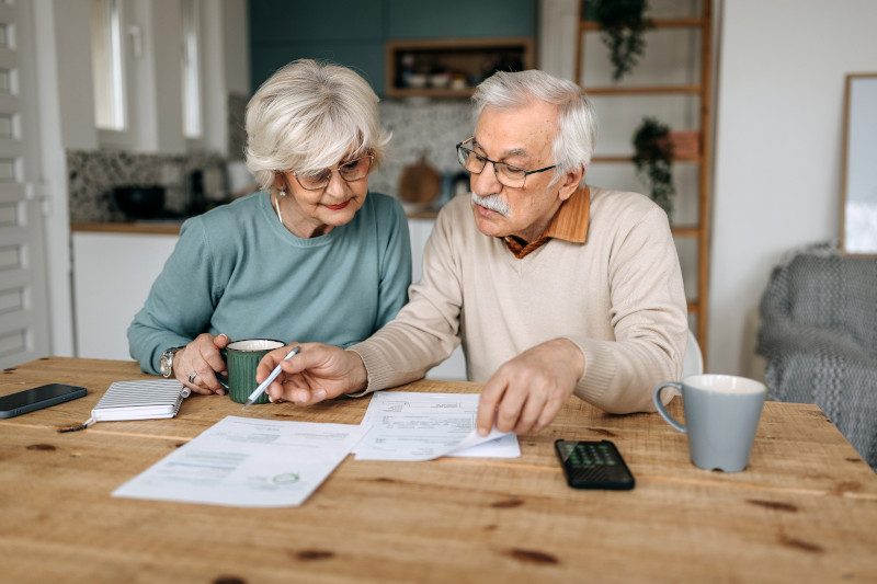 A couple goes over their financial bills in their kitchen.