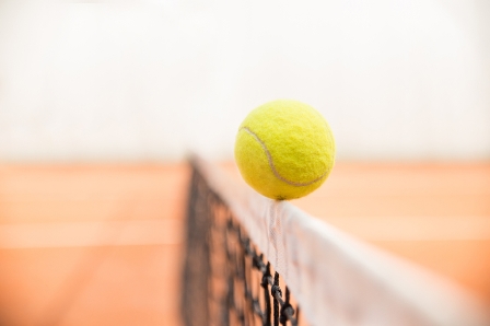 Tennis ball hitting the net