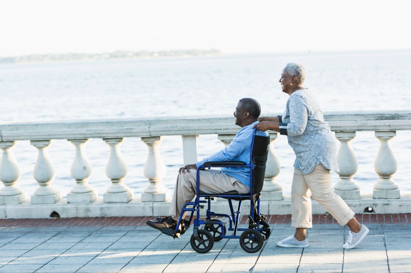 Senior African American couple, man in wheelchair