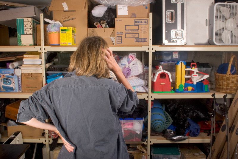 Woman searching through full shelves