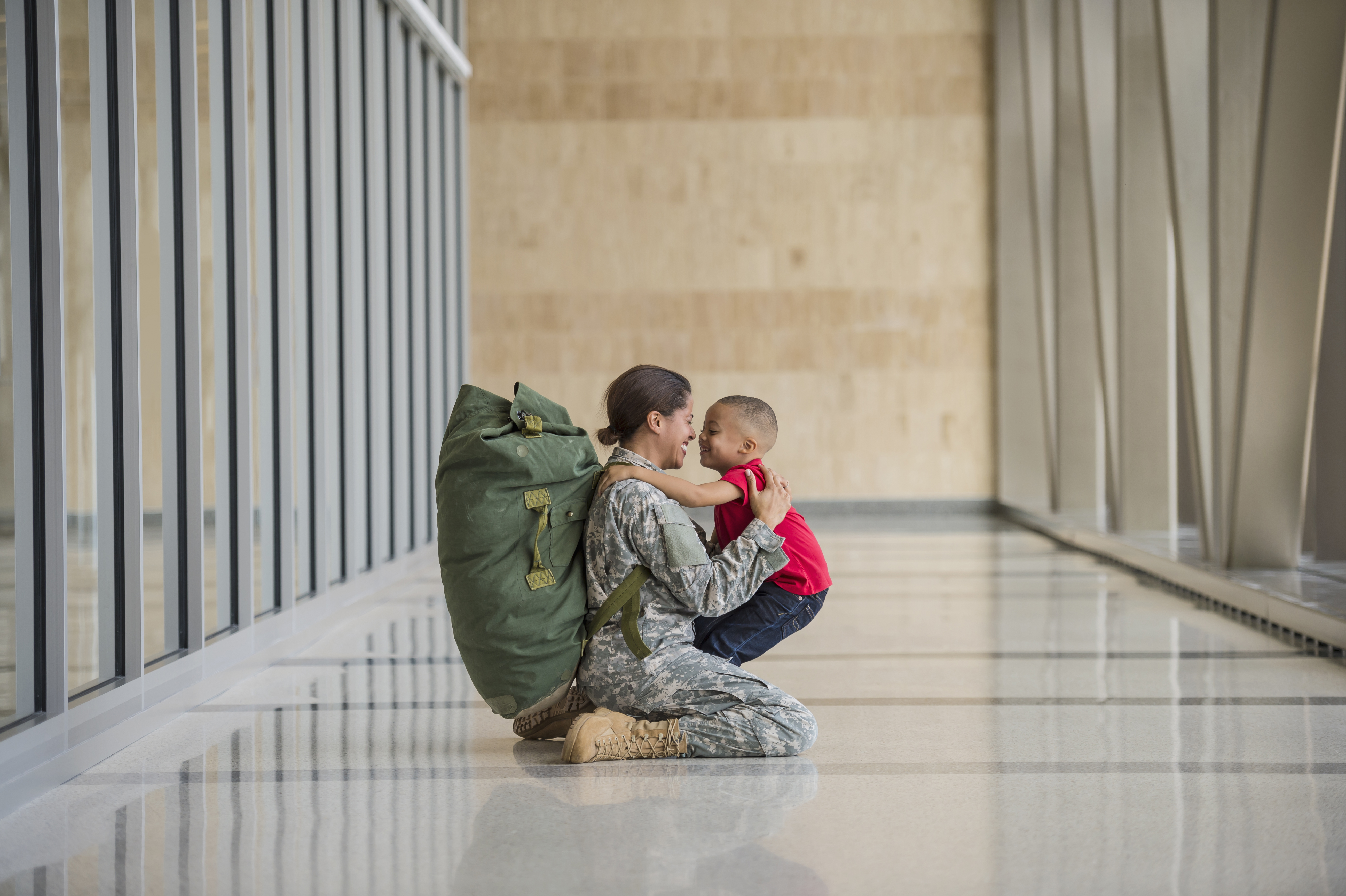African American soldier hugging son in airport