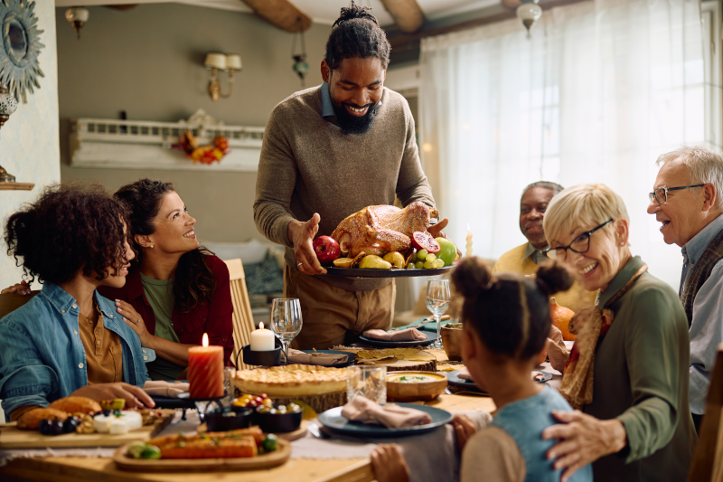 A family gathers around the table for a holiday meal.