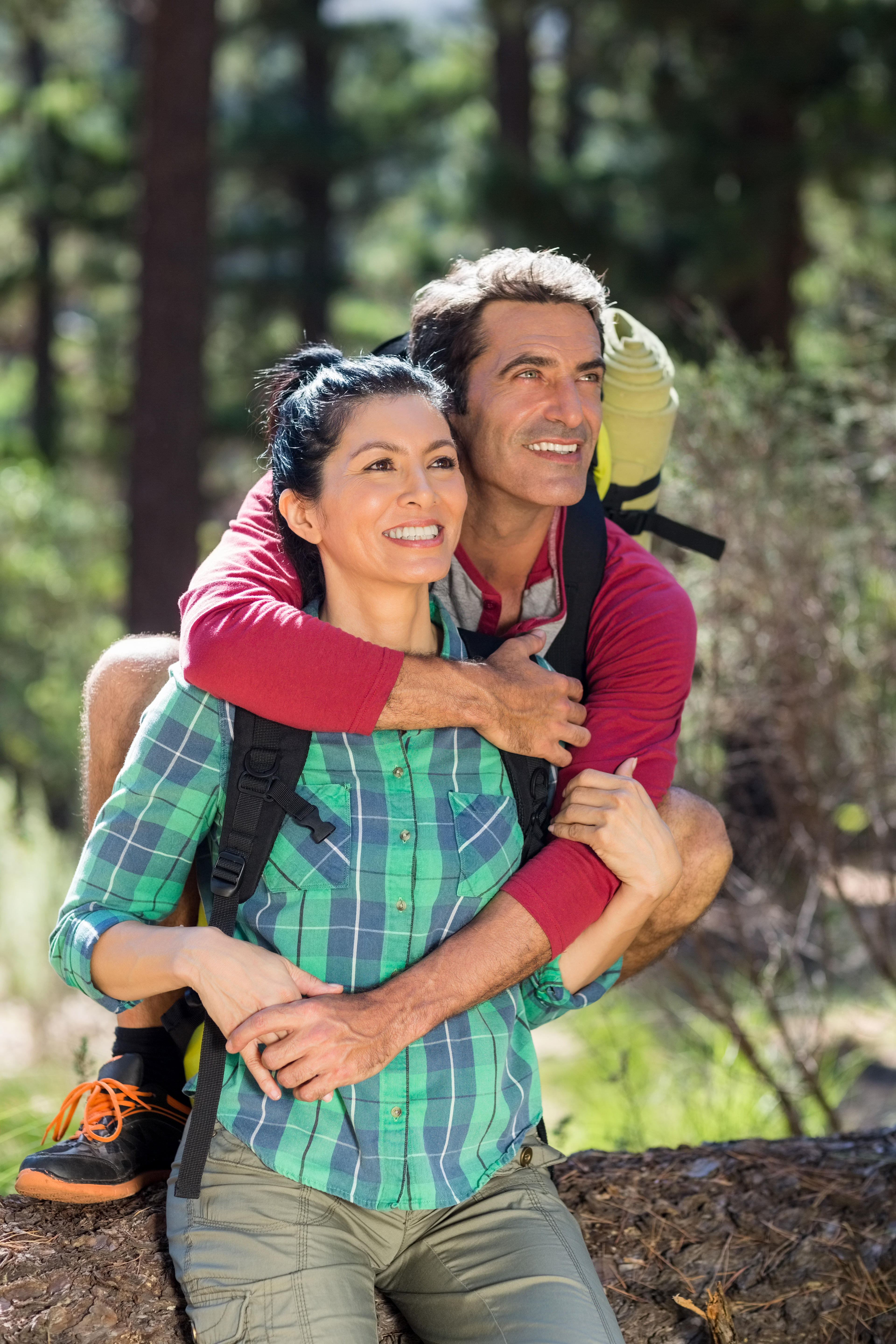Couple smiling and holding each other on the wood