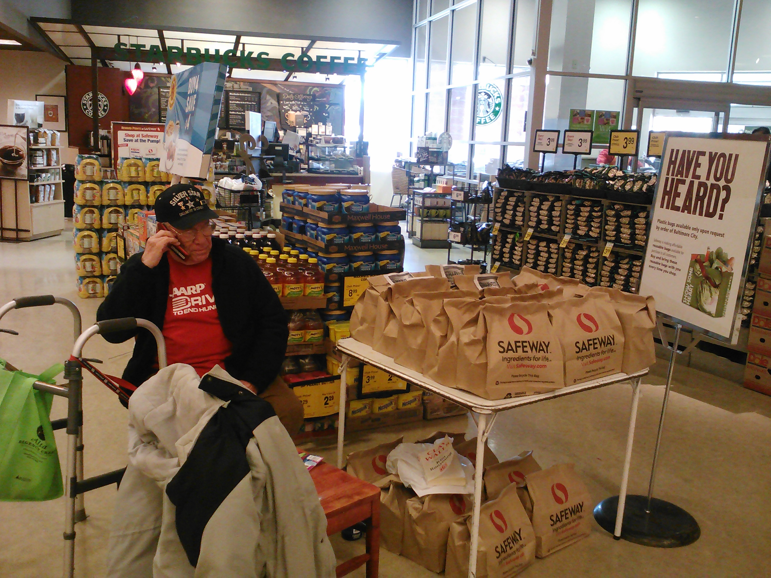 AARP Maryland volunteer Marvin Sakin volunteers at a food donation table in Baltimore.
