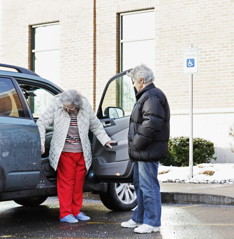 Elderly Woman Backing Into Car Front Seat