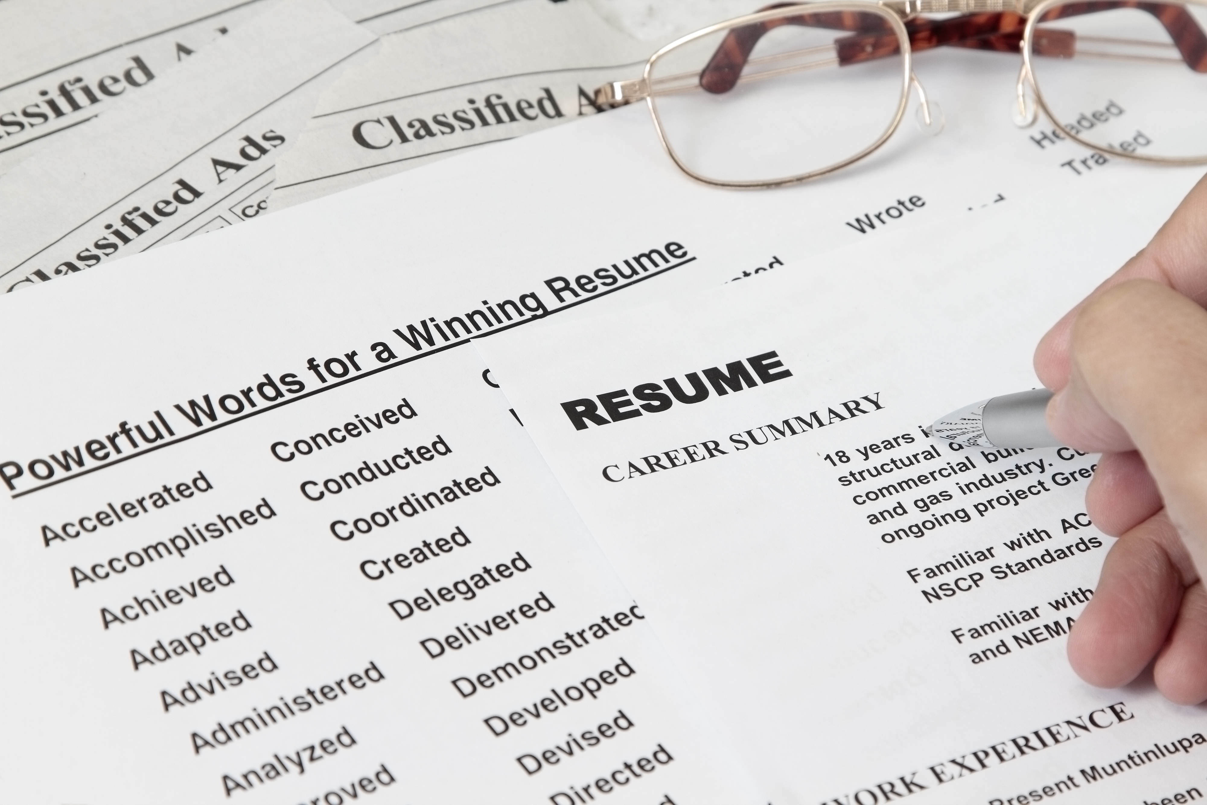 A list of words and a person writing a resume