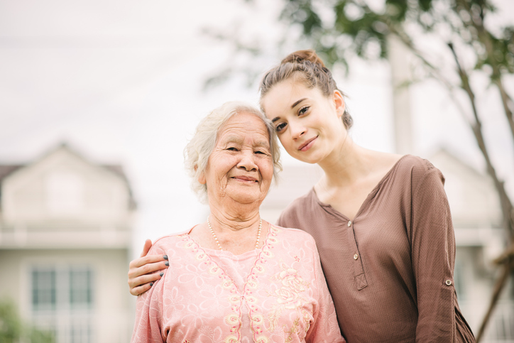 woman hugging elderly Asian woman
