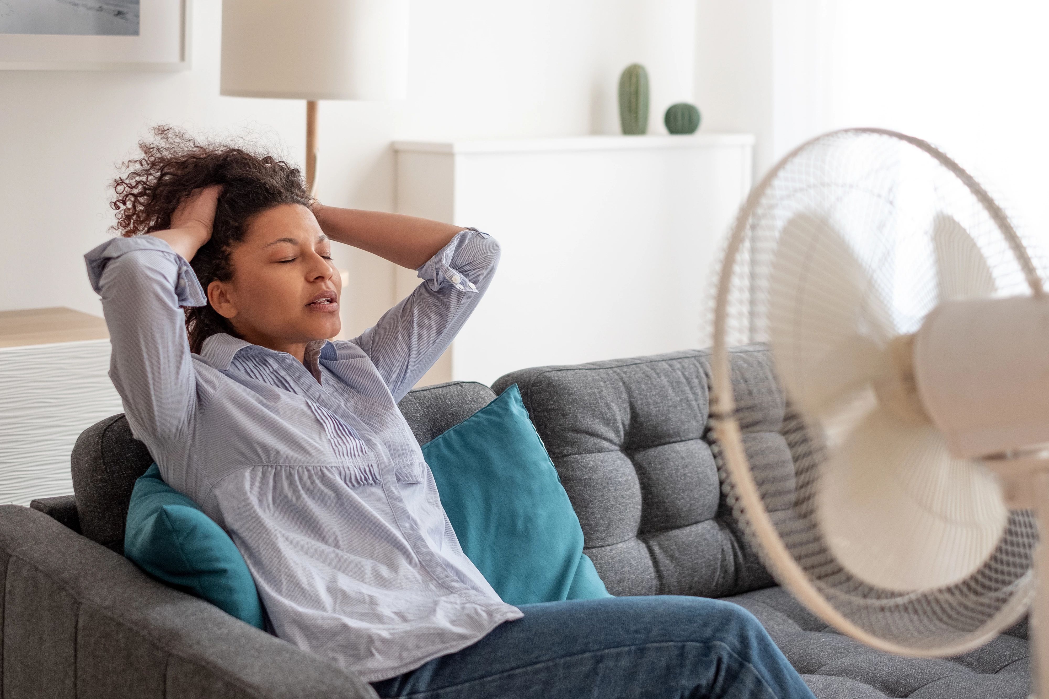 Woman with fan blowing