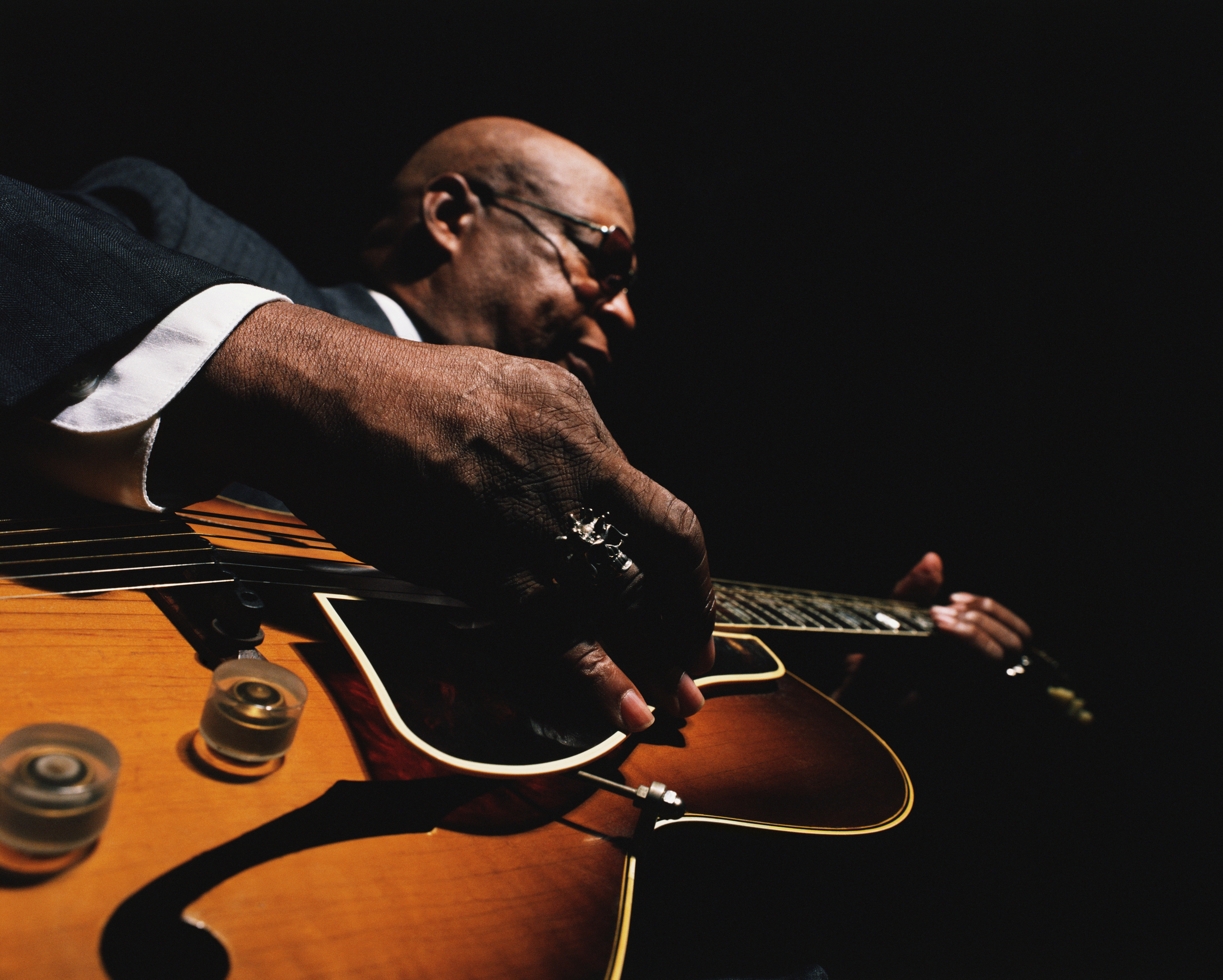 African American man playing guitar