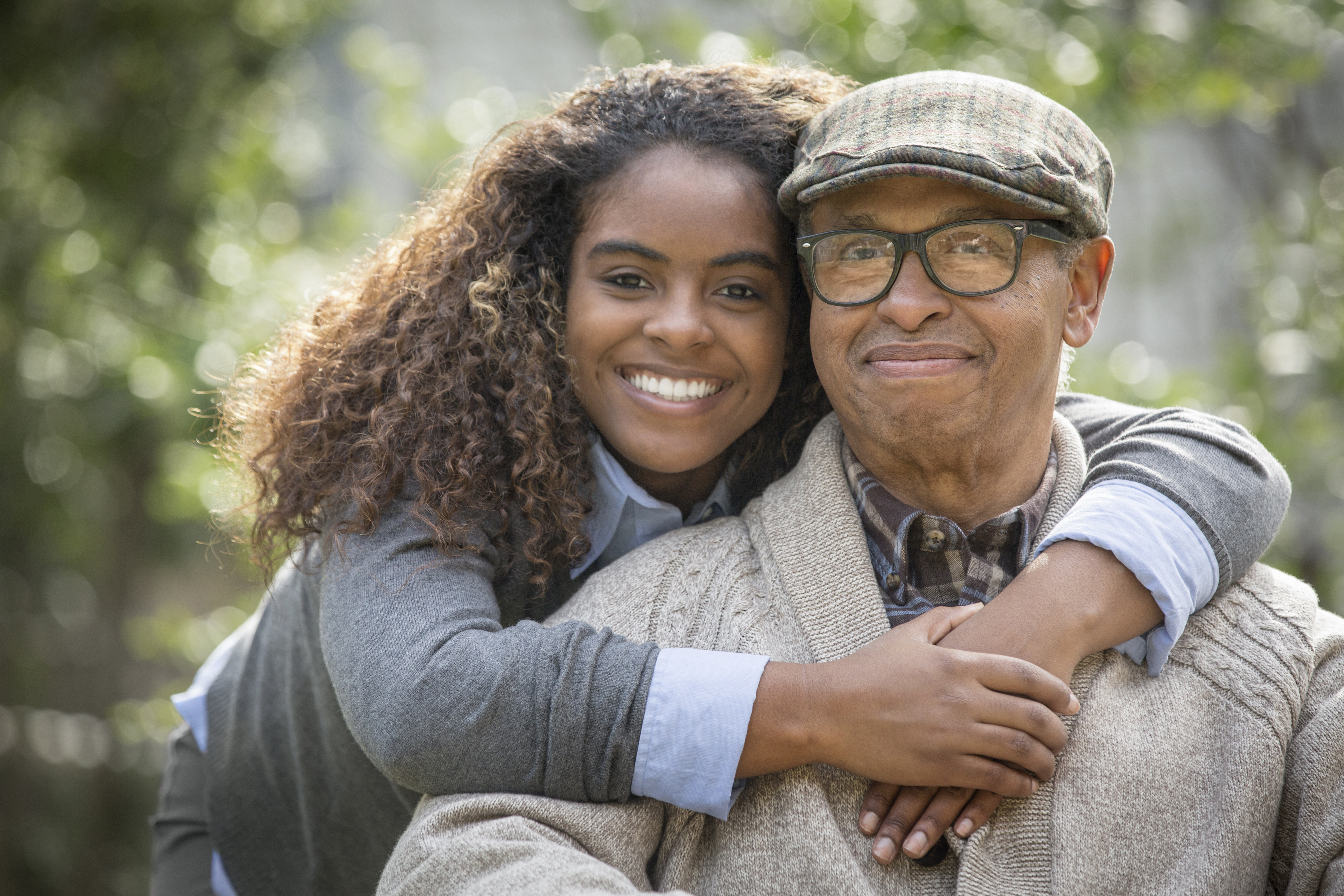 African American woman hugging father outdoors