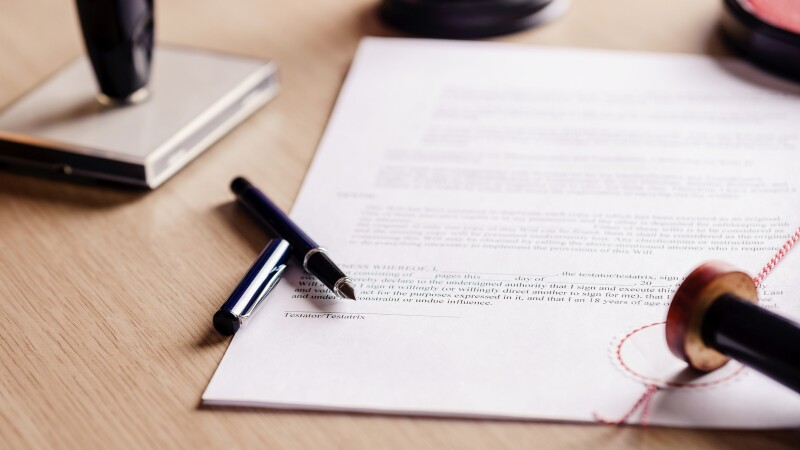 Notary pen lying on testament.