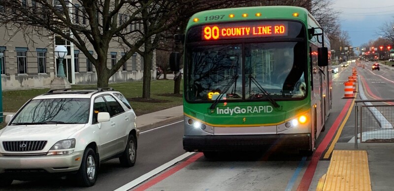 An IndyGo Red Line bus pulls up to one of its stops on Meridian Street in Indianapolis.
