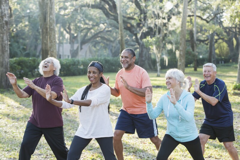 Multi-ethnic group of seniors taking tai chi class