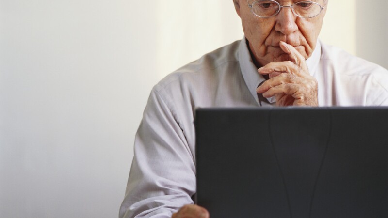 Pensive Businessman Using Laptop