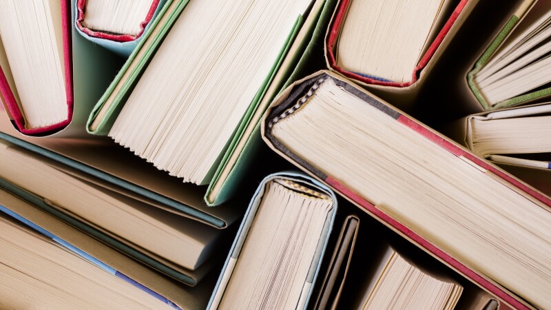High angle view of many hardback books. Library or school.